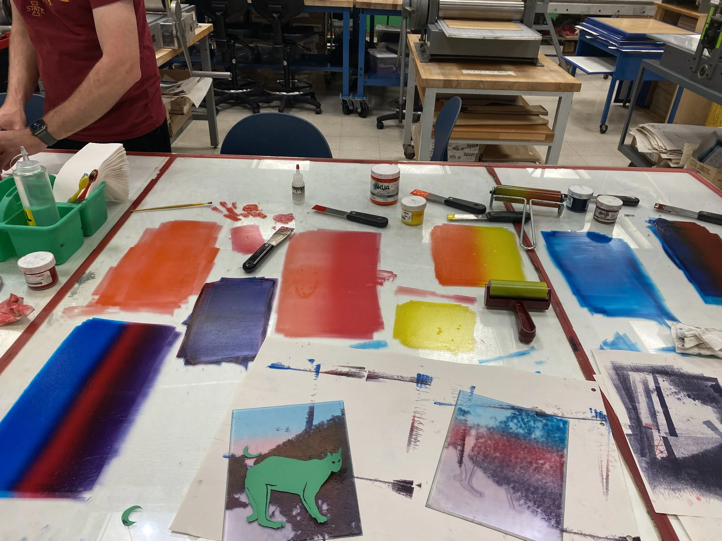 inks and plates out on a glass table