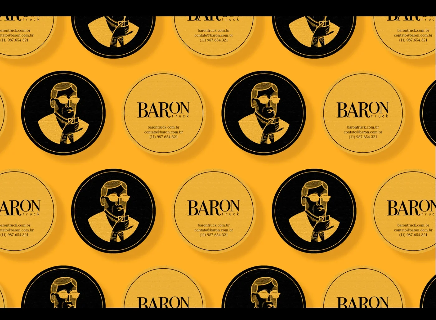 Adesivos de logo da marca "Baron Truck" com ilustração de homem de barba, óculos de sol e segurando um telefone, em fundo amarelo e preto, com informações de contato.