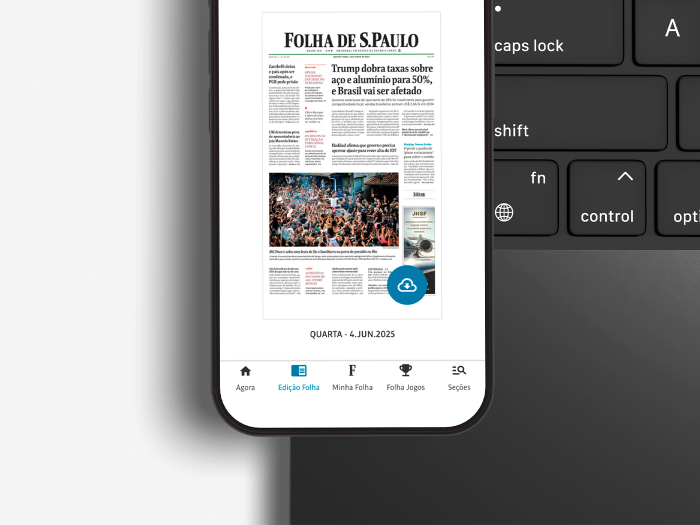 Tela de um smartphone exibindo um jornal impresso, Folha de S.Paulo, com a data Quarta-feira, 4 de junho de 2025, ao lado de um teclado de computador.