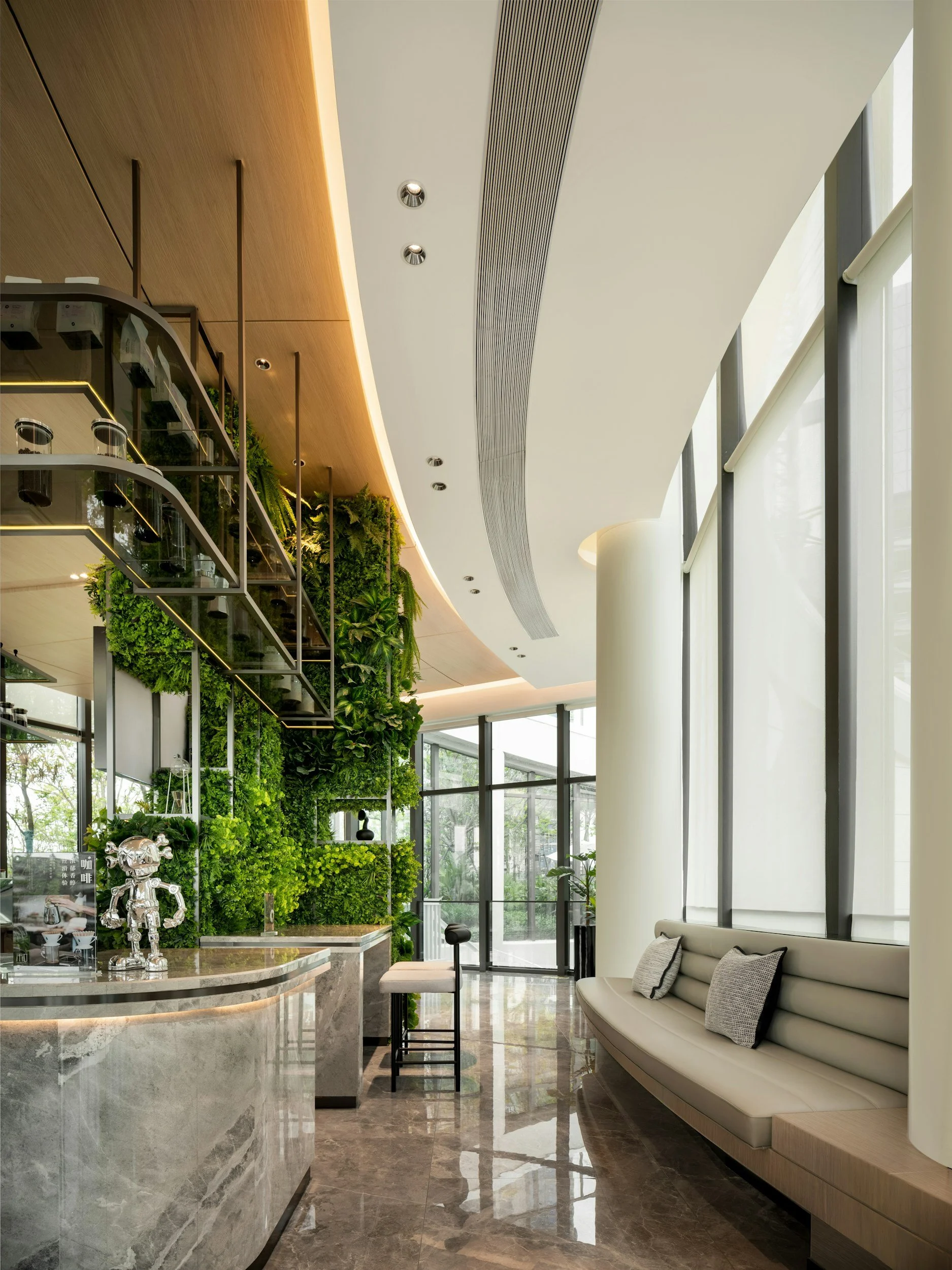 Bright modern office lobby with green plant walls and seating