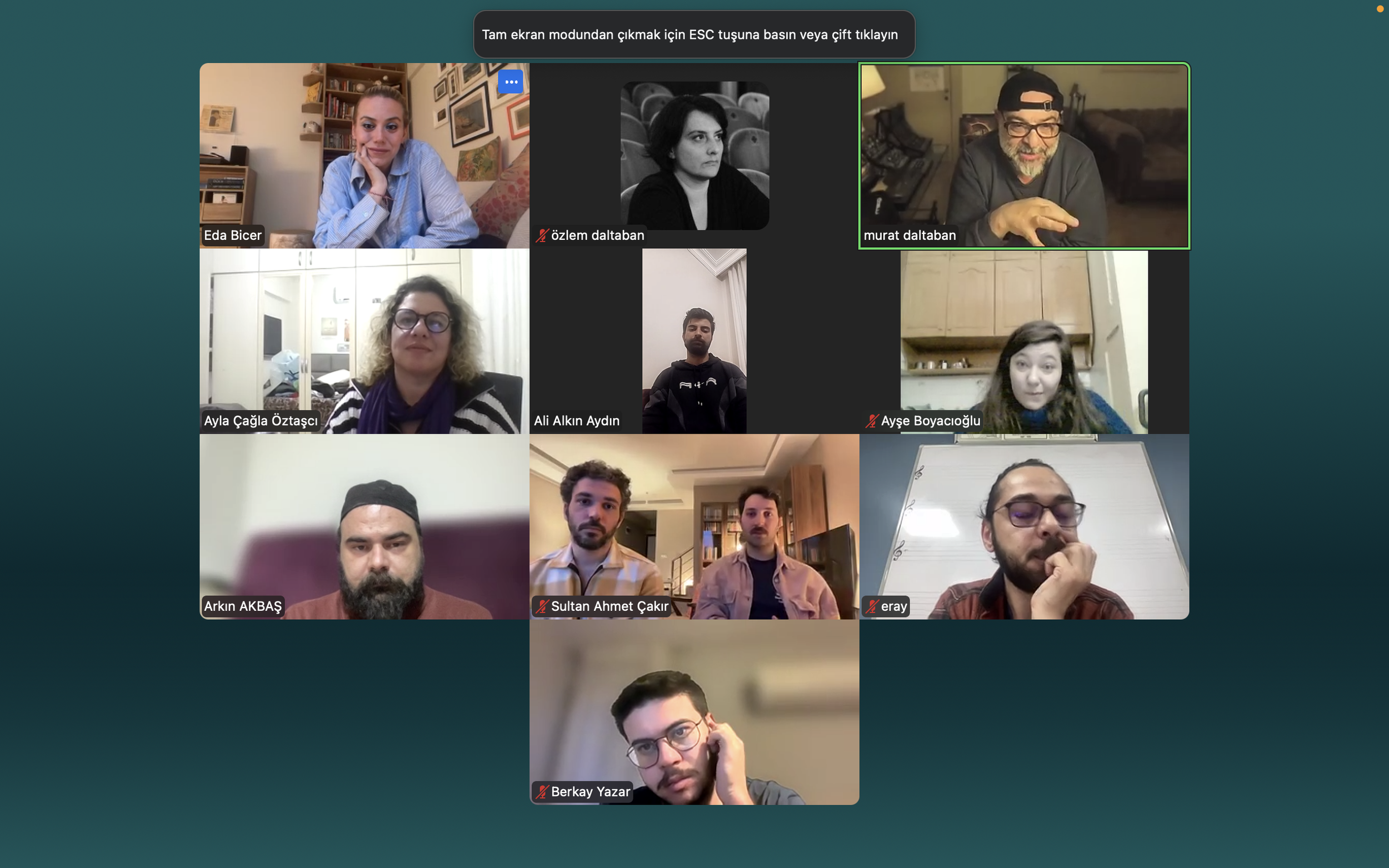 Screenshot of a video conference call with multiple participants, each visible in individual video windows. The screen displays names and some participants are speaking while others are listening.