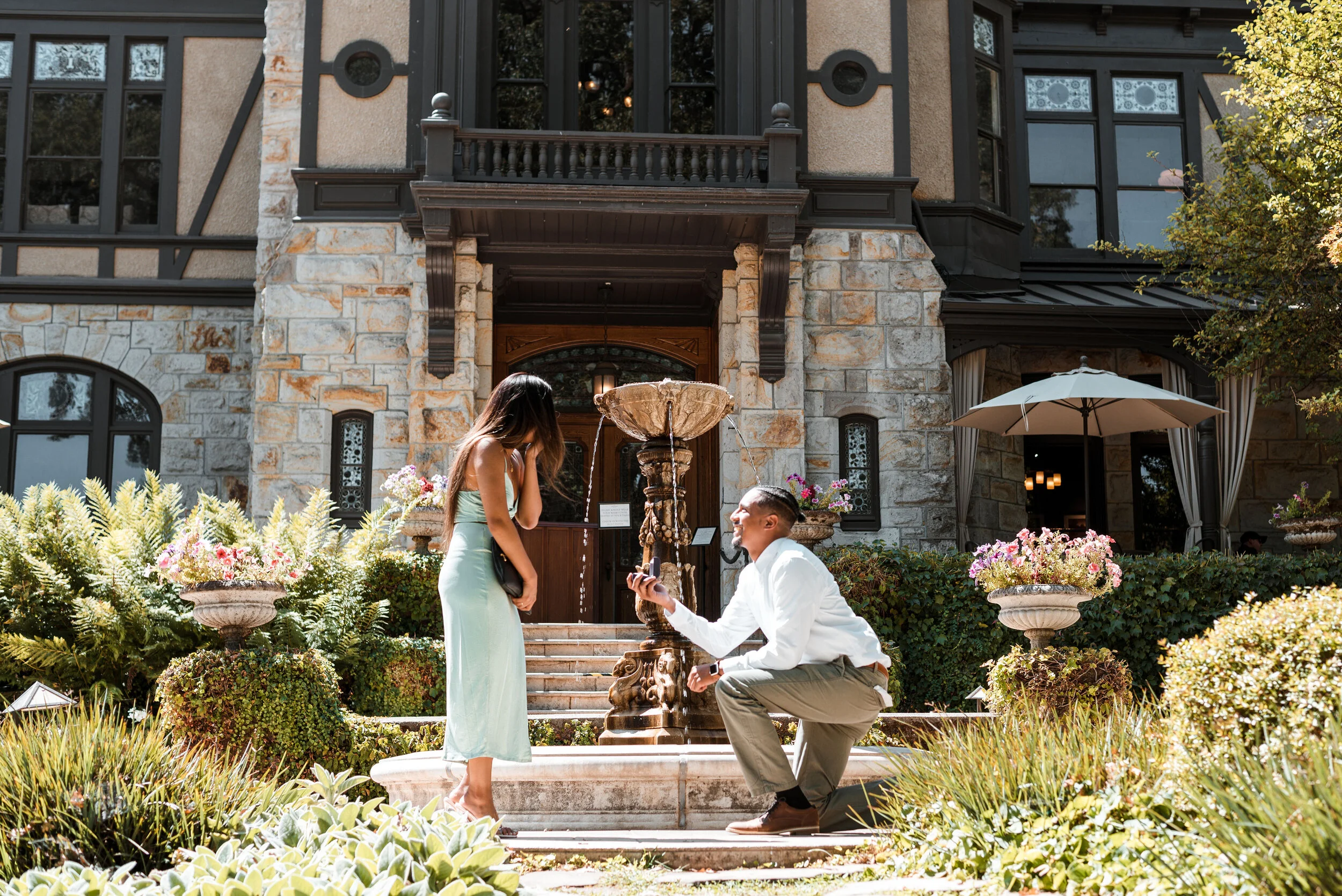 Lyndsi Seth Photography-A surprise marriage proposal outdoors in front of an estate and stone fountain