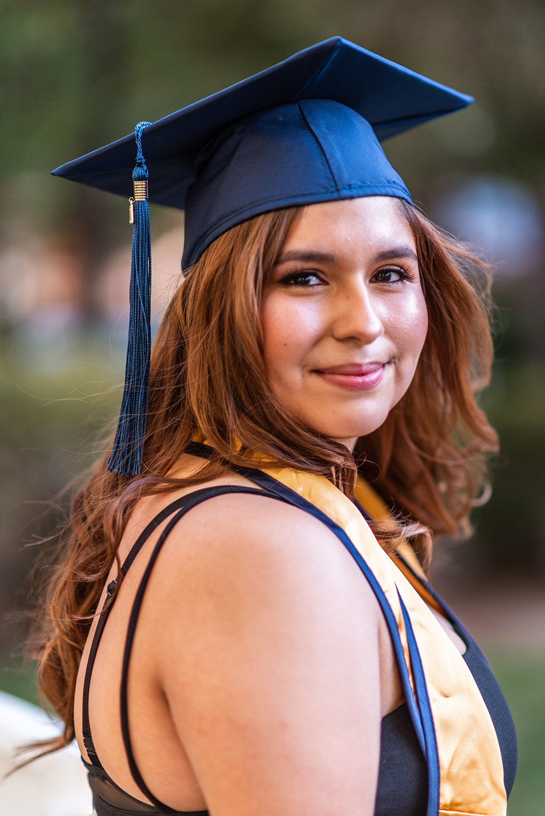 Lyndsi Seth photography- A portrait of a happy female graduate wearing her blue graduation cap
