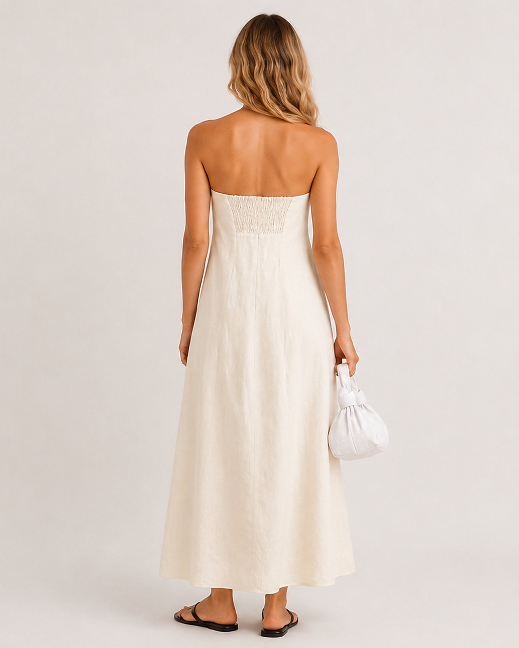 Full back view of the Sand Strapless Linen Dress, showing the centred shirred panel and A-line maxi hem.