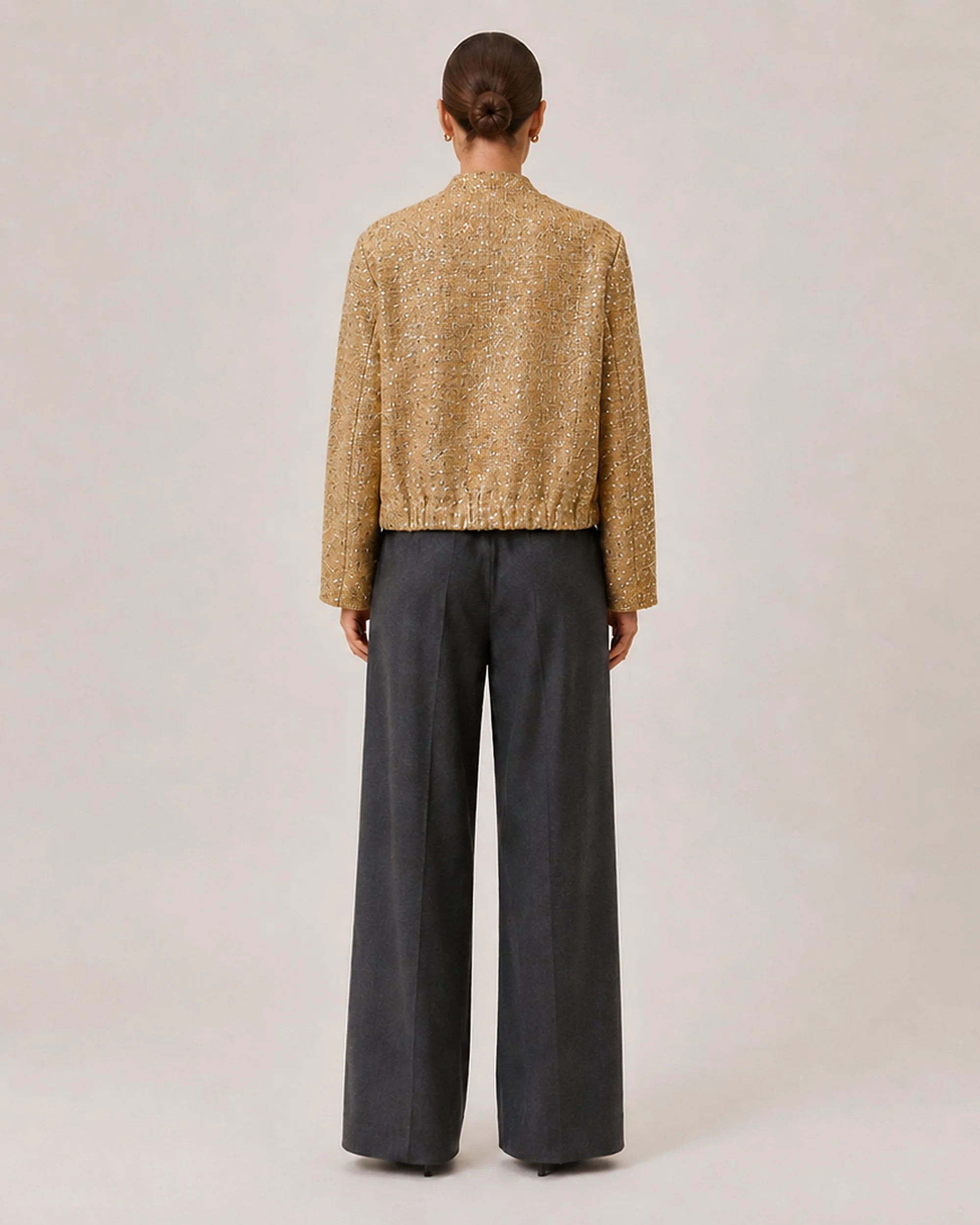 Back view of The Flax Studio Textured Gold Jacket, showing the long sleeves and gathered hem.