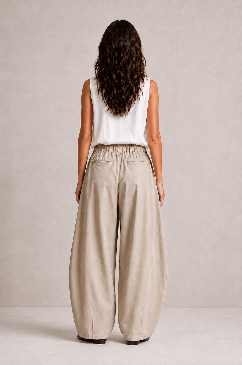 Back view of The Flax Studio tan Esme Pant, showing the relaxed fit and back welt pockets.