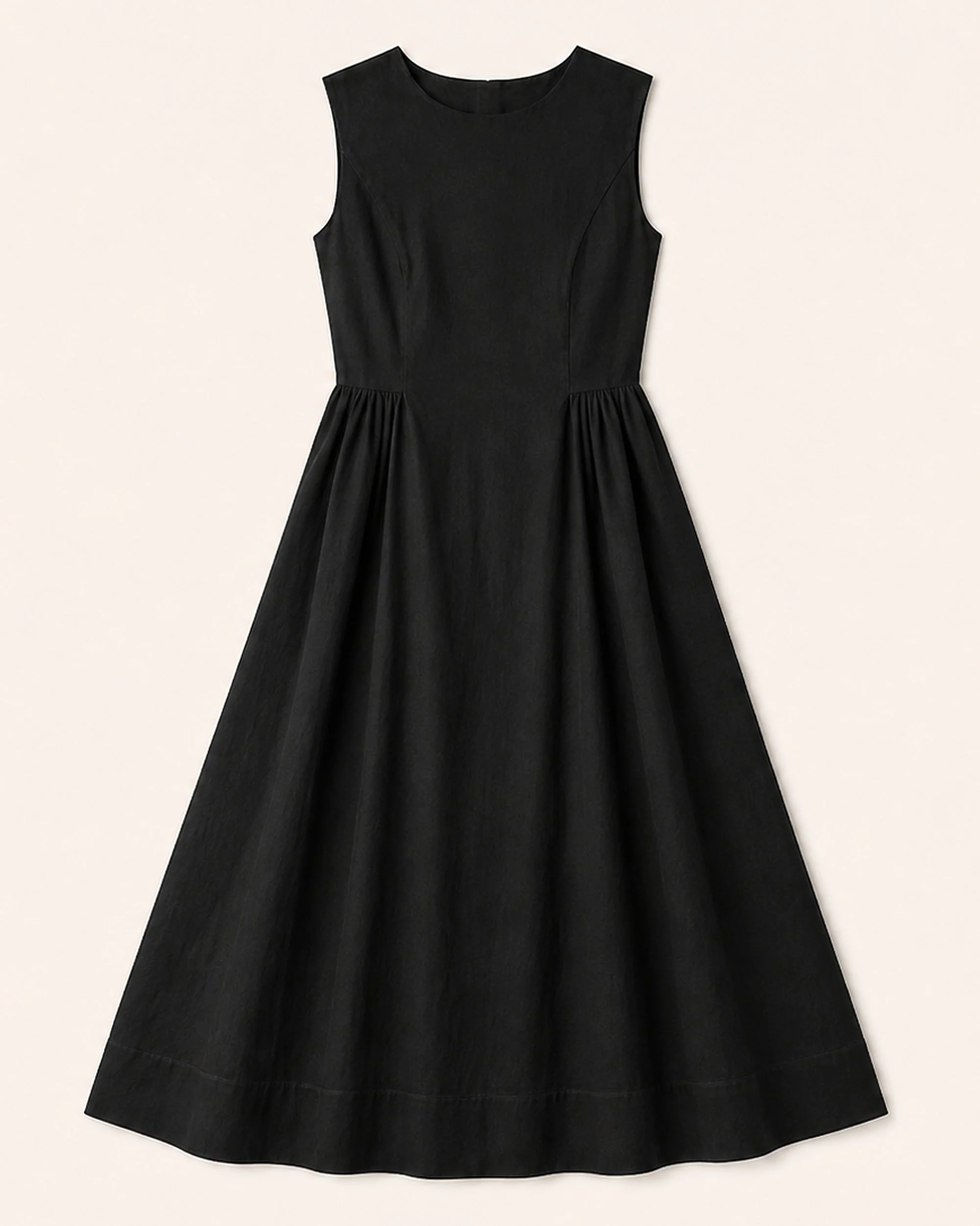 Flat lay of The Flax Studio black Tailored Dress, showing its shaped waist and flared skirt.