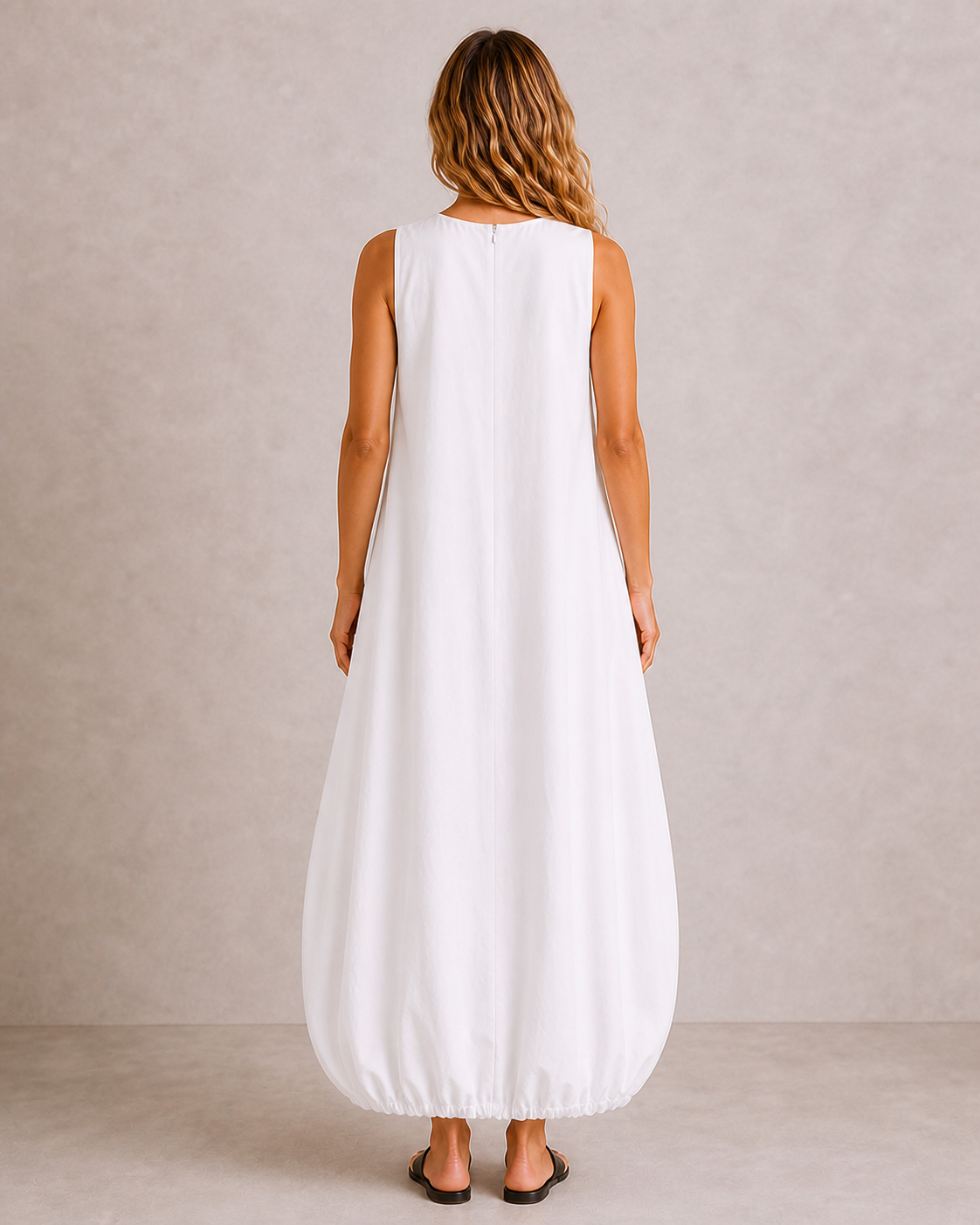 Back view of The Flax Studio white Arc Dress with a clean sleeveless bodice and rounded skirt.