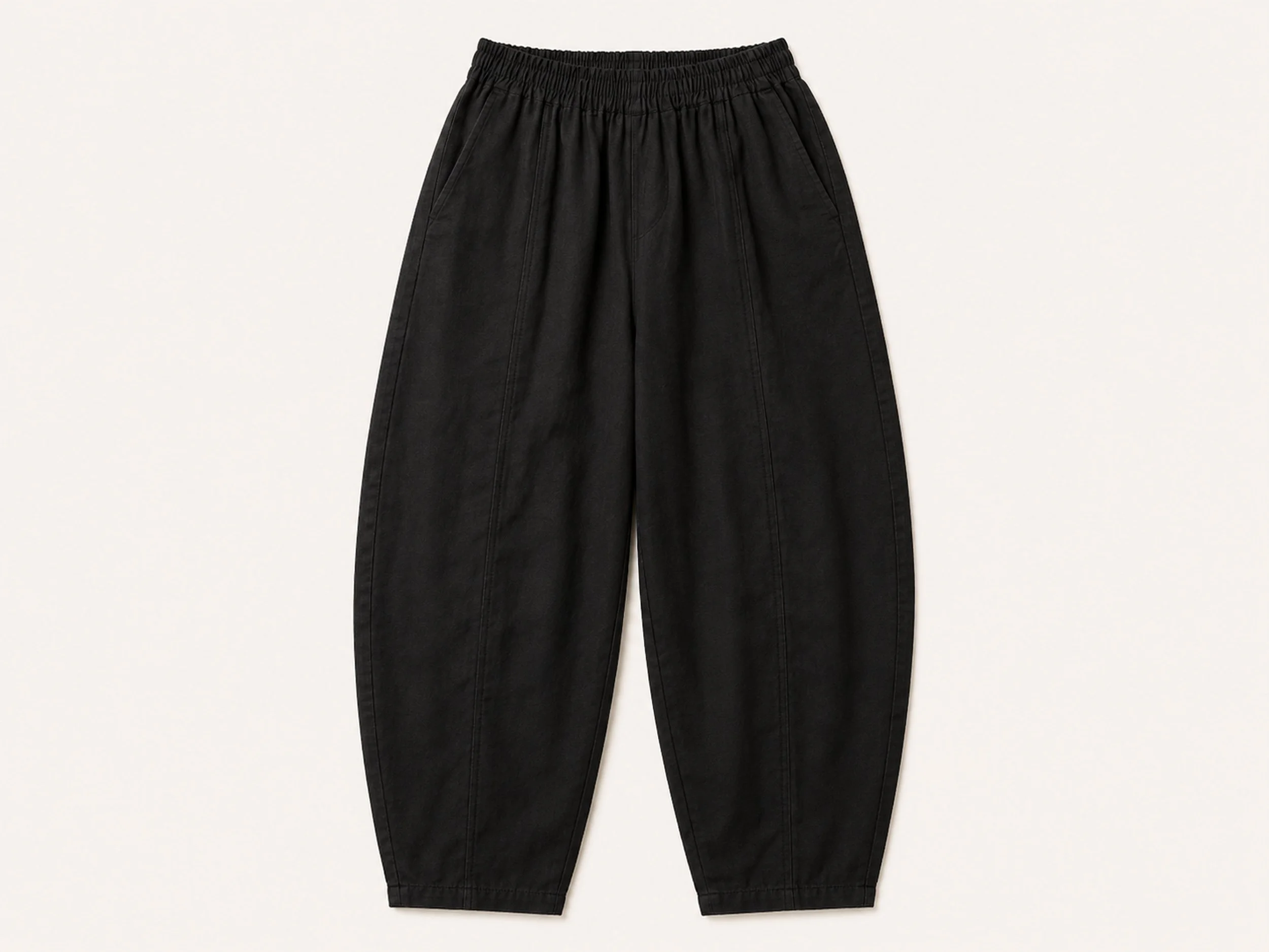 Flat lay of The Flax Studio black Sculpted Cotton Pant with an elasticated waist and curved legs.