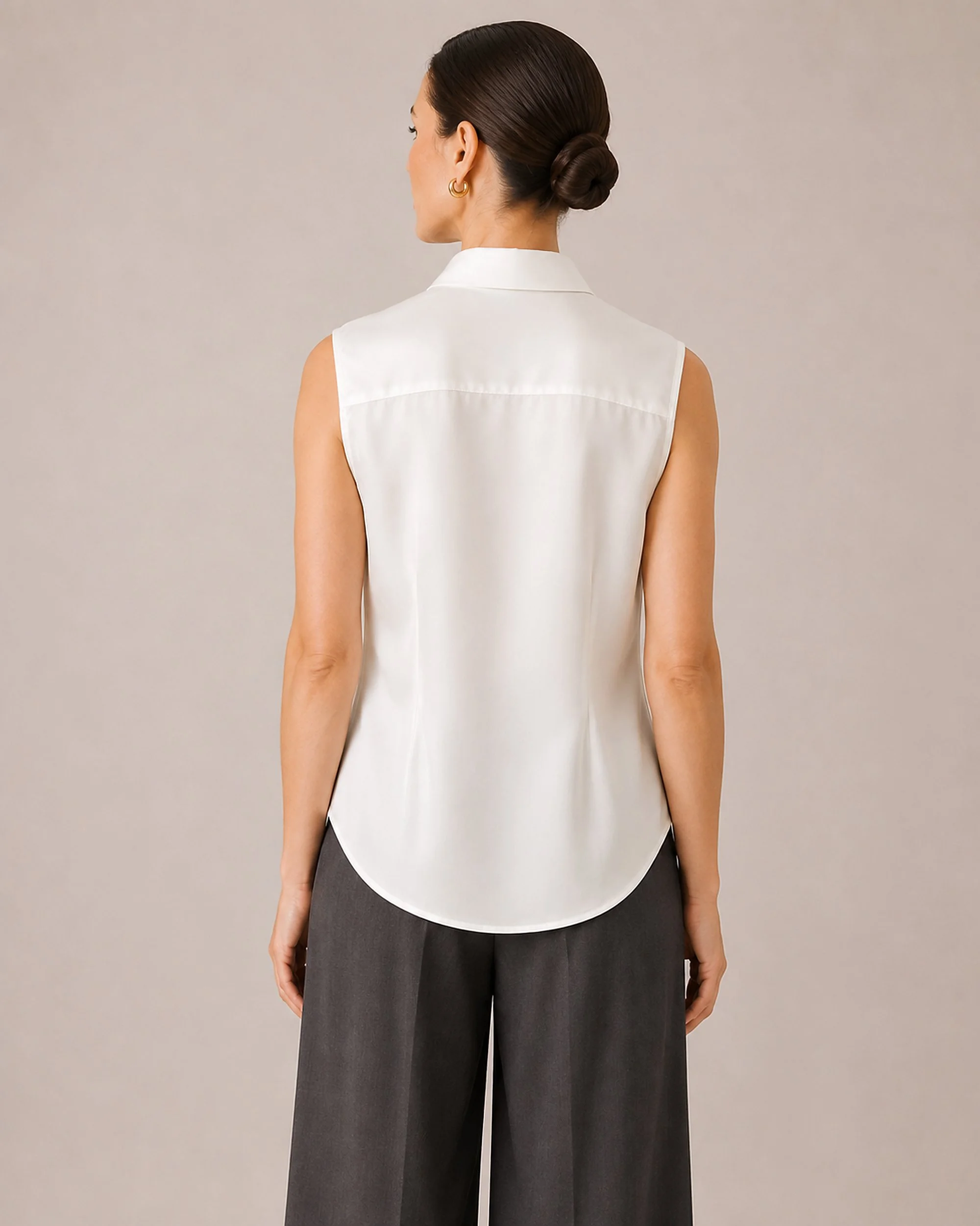 Back view of The Flax Studio white Mulberry Silk Sleeveless Blouse, showing the curved shirttail hem.