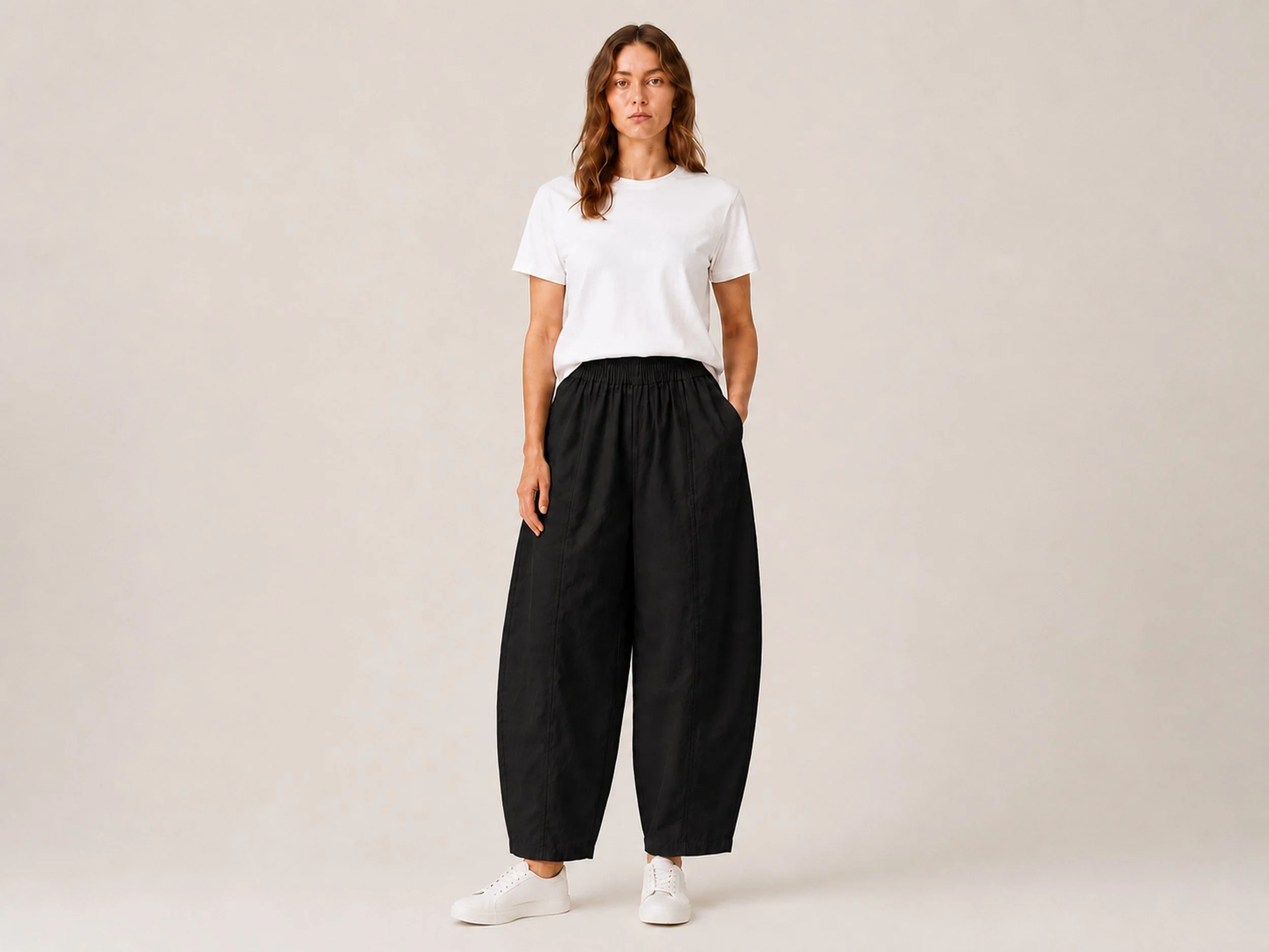 The Flax Studio black Sculpted Cotton Pant styled with a white T-shirt and white shoes, front view.