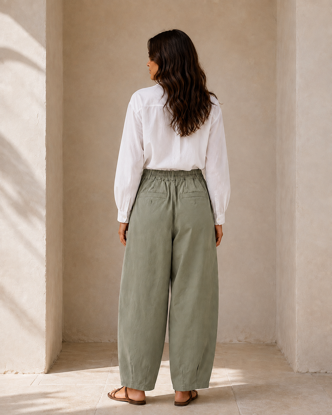 Back view of The Flax Studio khaki Button Front Crepe Pant, showing the gathered waist and rear pockets.