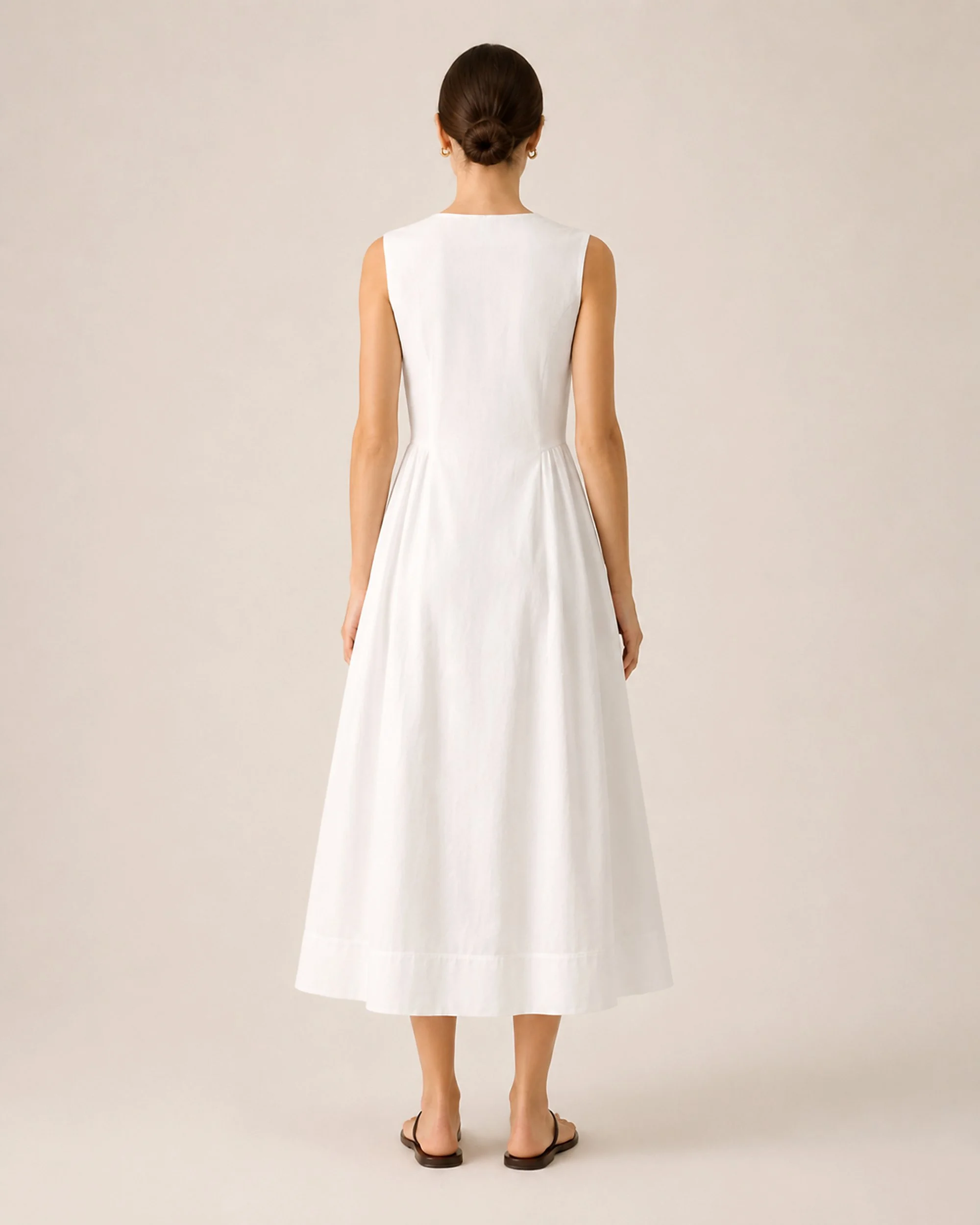 Front view of The Flax Studio white Tailored Dress with a defined waist and ankle-length A-line skirt.