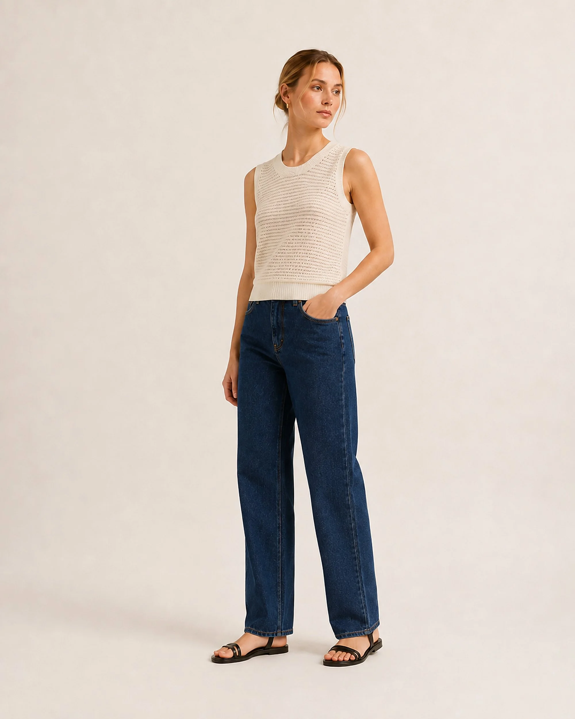 Angled view of The Flax Studio cream Open-Knit Silk-Cotton Tank styled with blue jeans.