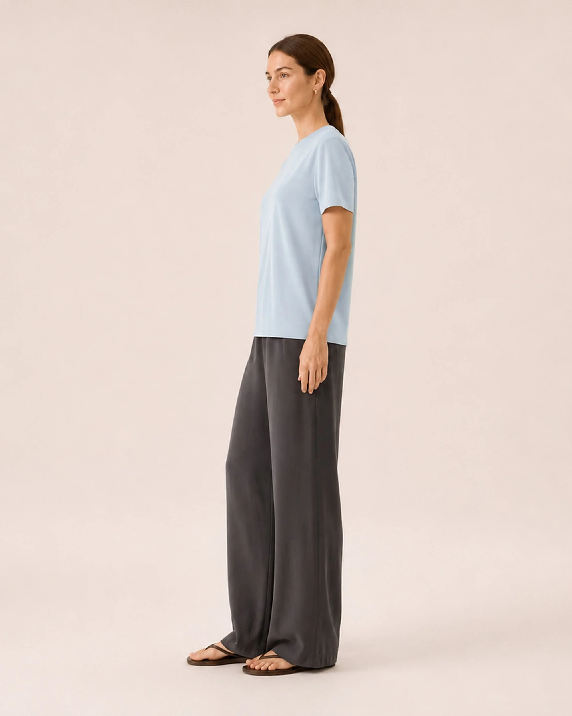 Side view of The Flax Studio blue Silk Crew Neck Top, showing its short sleeves and relaxed drape.