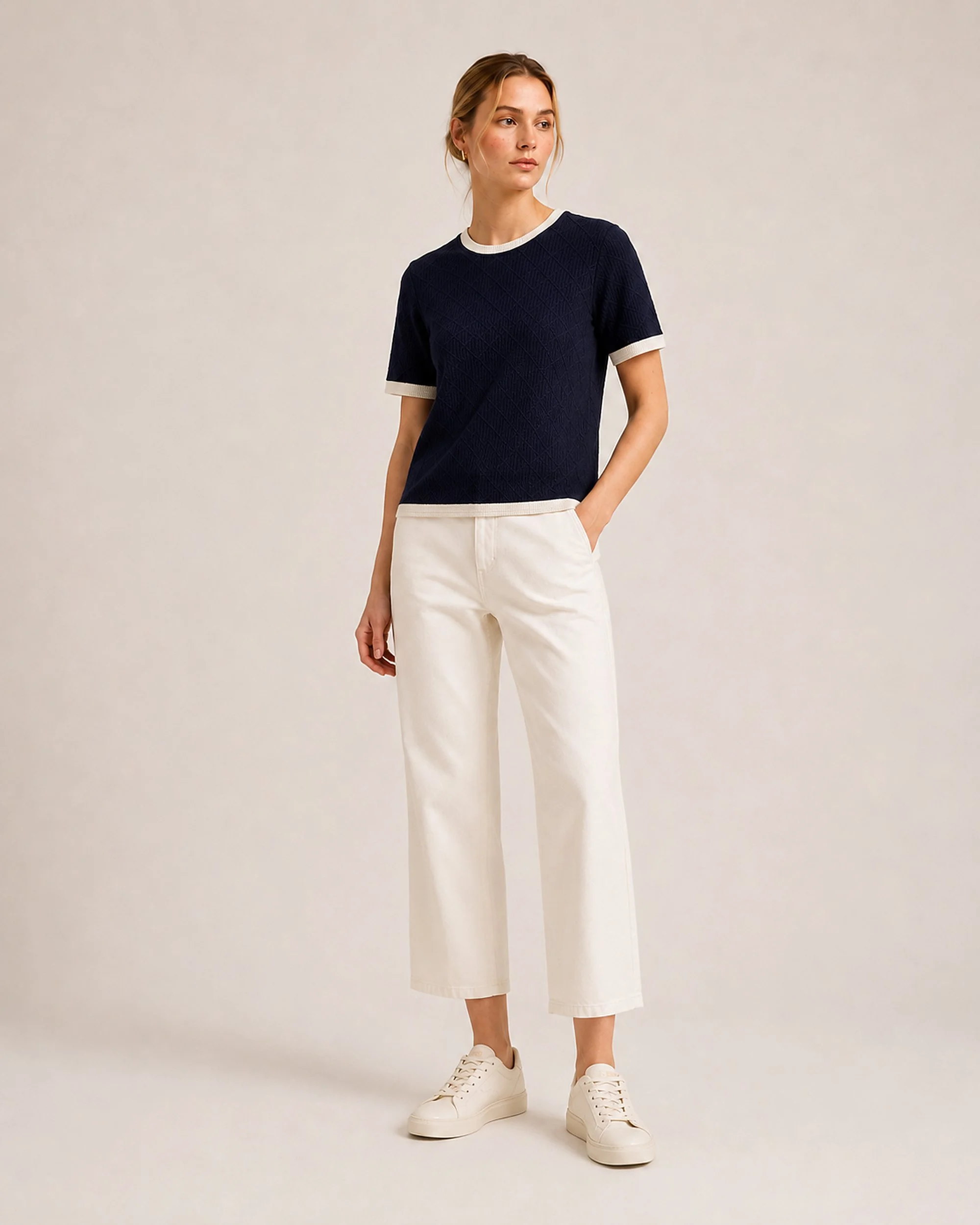 Angled front view of The Flax Studio navy Contrast-Trim Silk-Cotton T-Shirt styled with cream trousers.