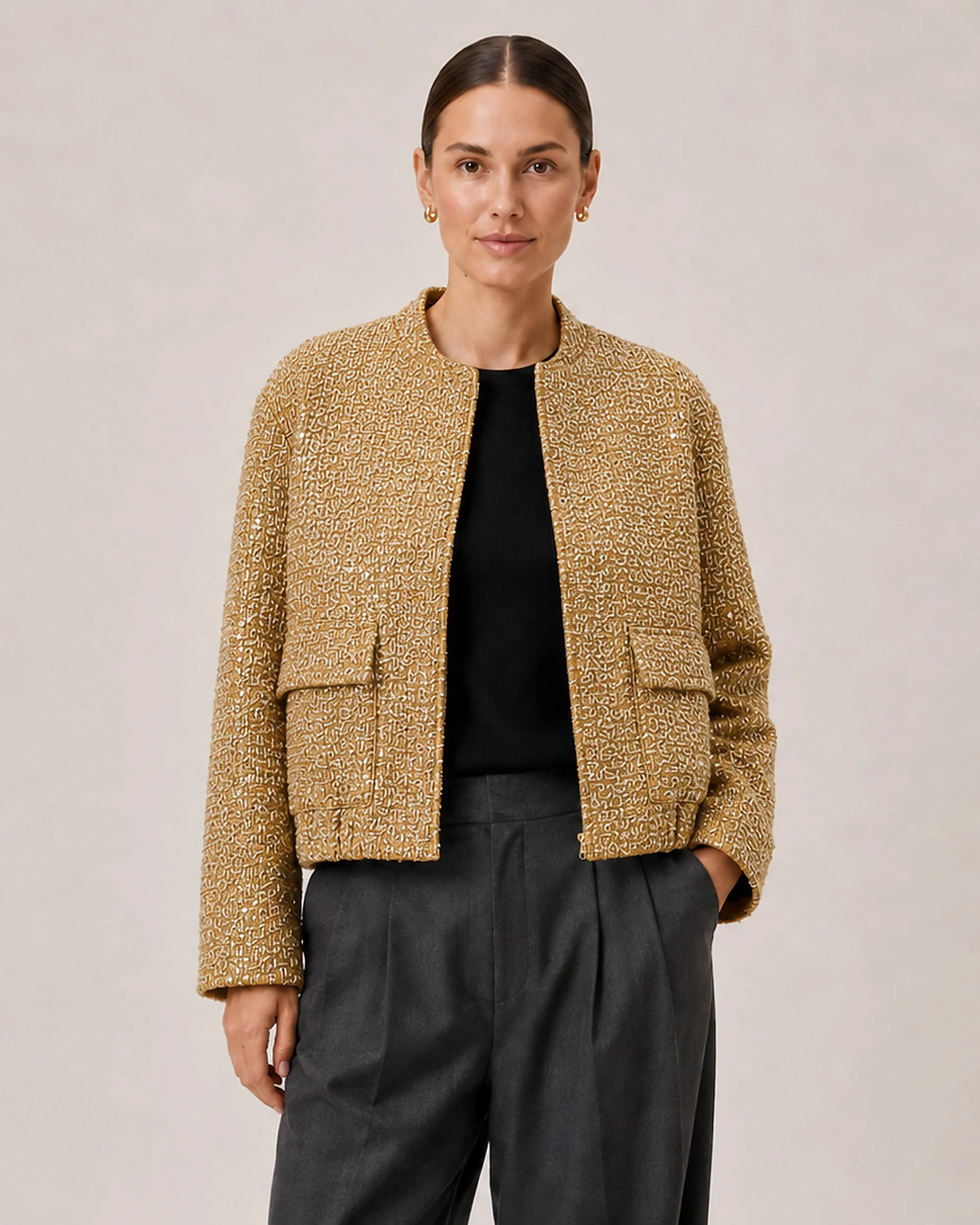 Front view of The Flax Studio Textured Gold Jacket worn open over a black top.