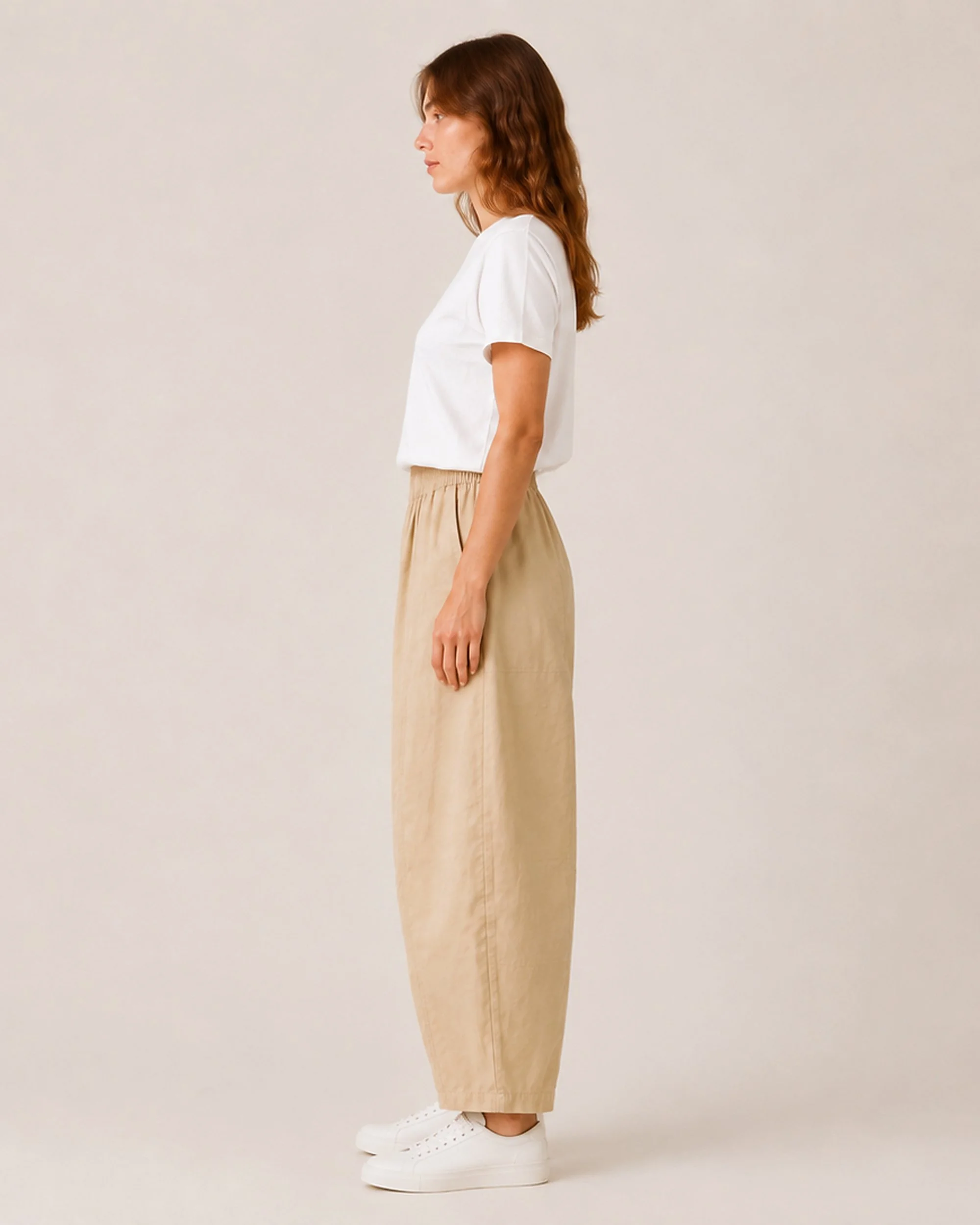 Side view of The Flax Studio tan Sculpted Cotton Pant, showing the relaxed shape through the hip and leg.