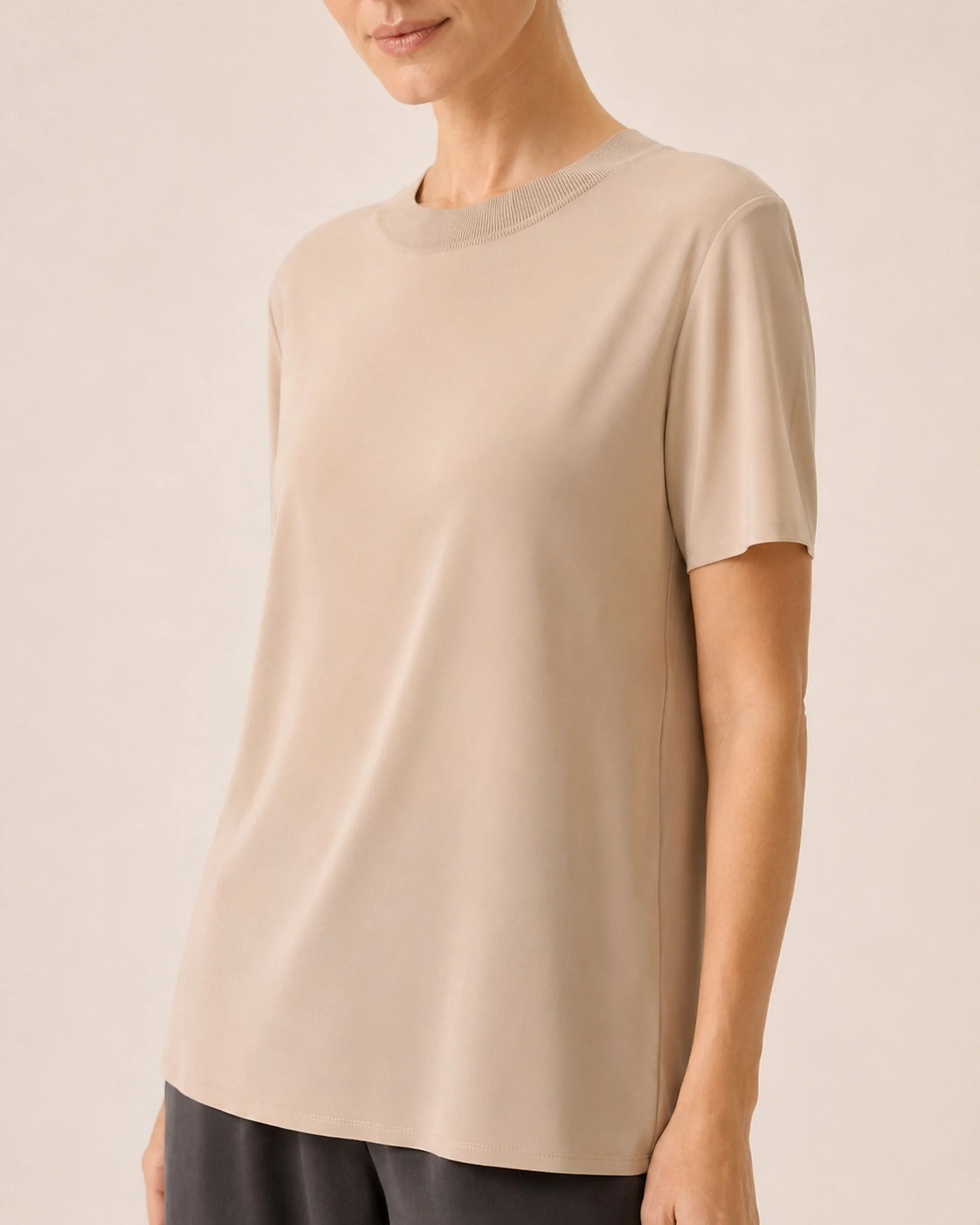Close-up of The Flax Studio beige Silk Crew Neck Top sleeve and softly draped body.