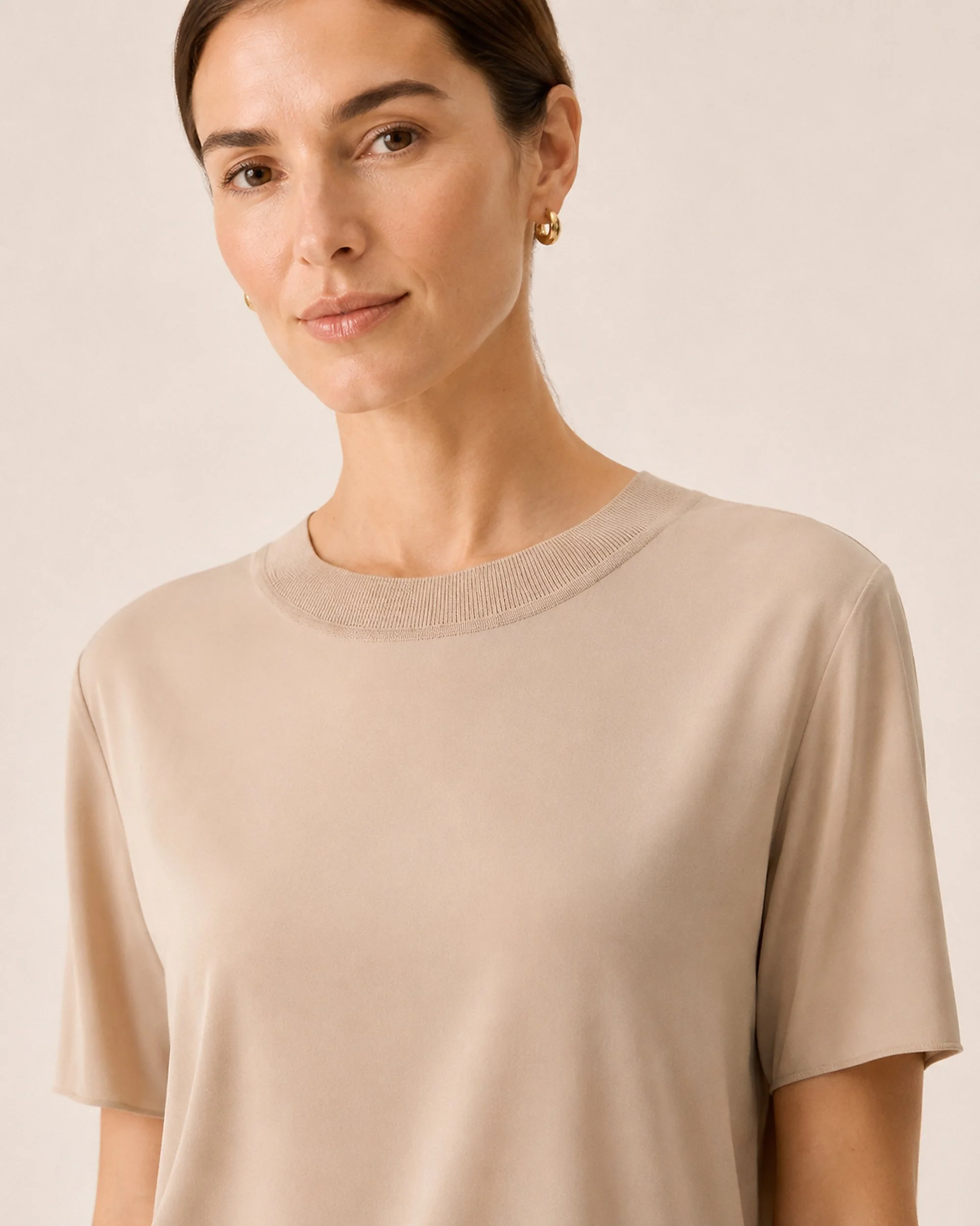 Neckline detail of The Flax Studio beige Silk Crew Neck Top, showing the smooth silk jersey.