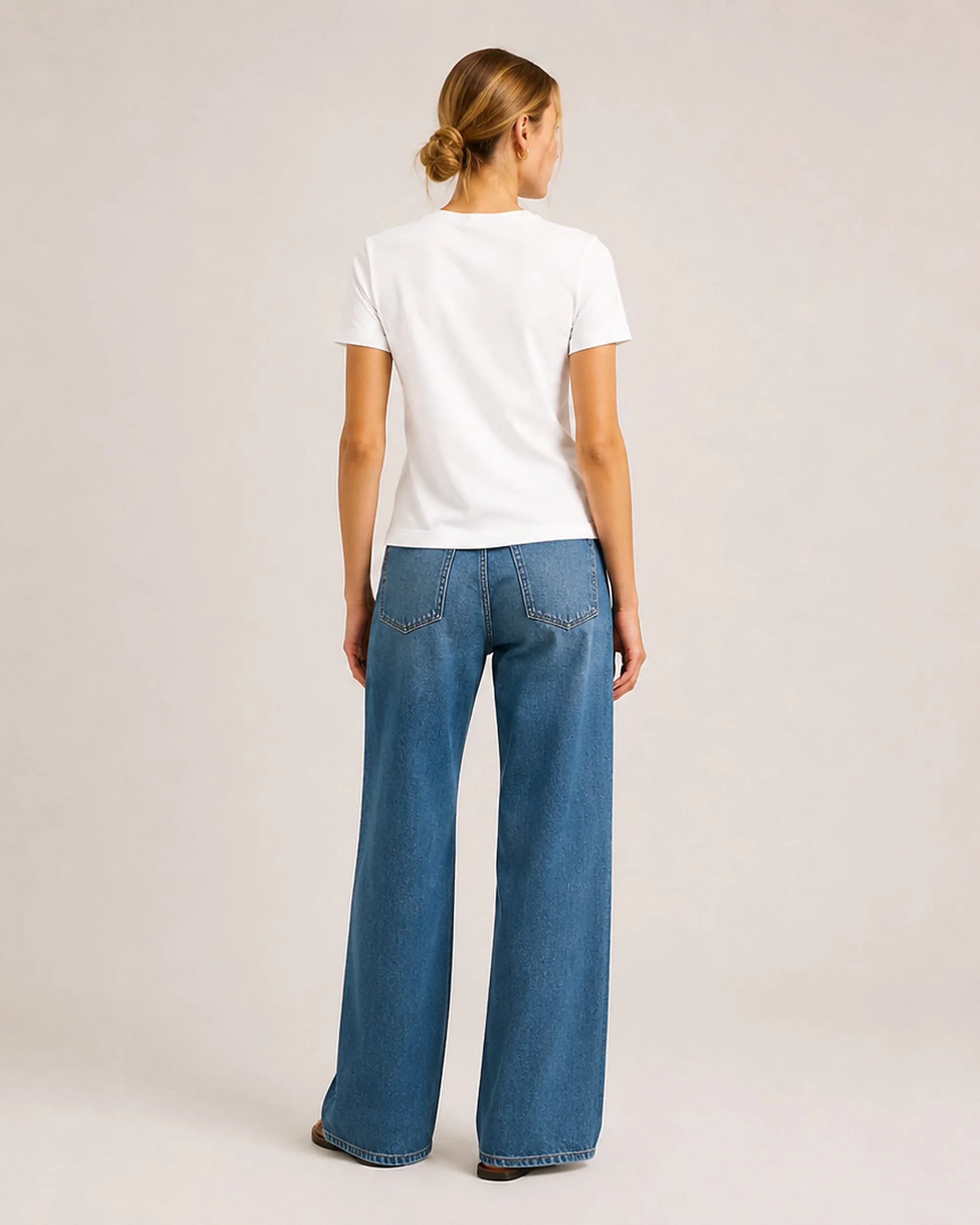 Back view of The Flax Studio white mercerised cotton T-shirt worn with blue jeans.