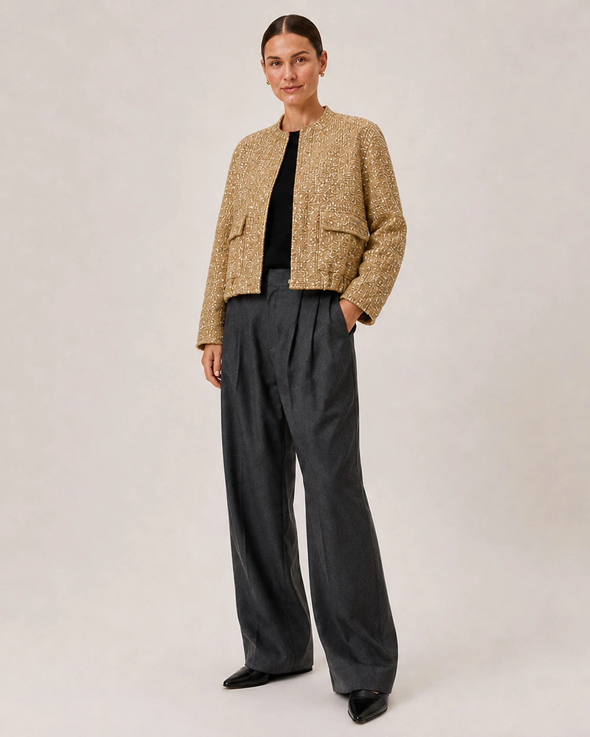 Angled view of The Flax Studio Textured Gold Jacket styled with black trousers.