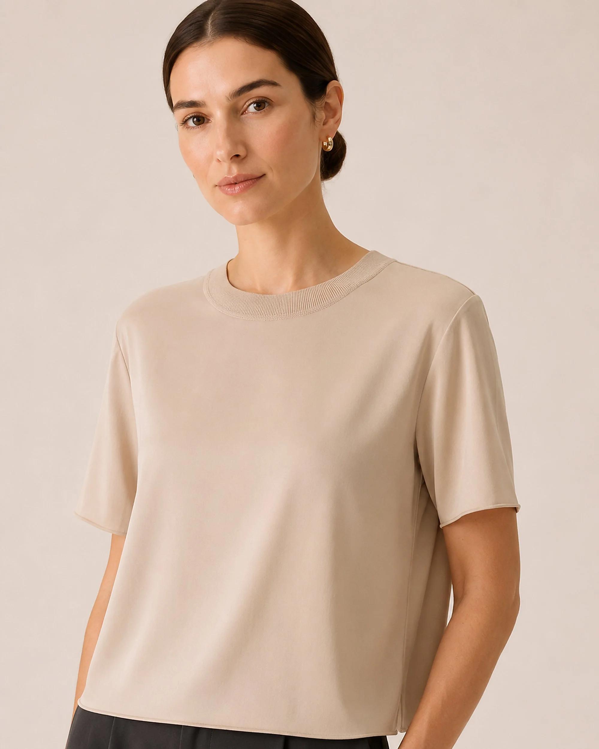 Close-up of The Flax Studio beige Silk Crew Neck Top, showing its crew neckline and short sleeves.