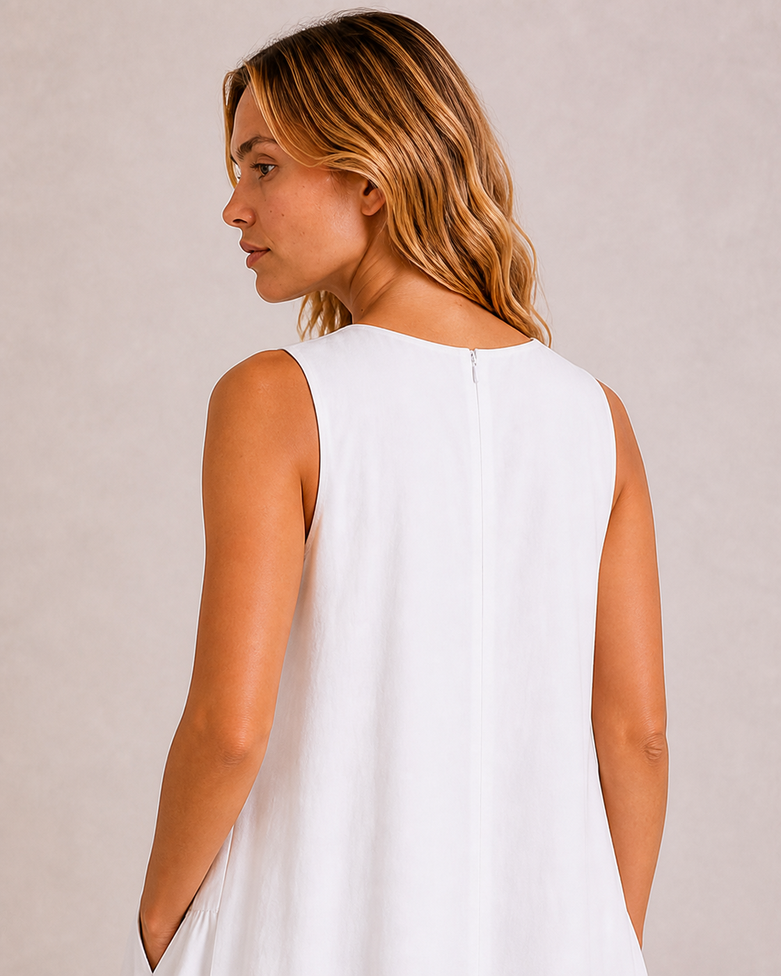 Close-up of the back neckline and concealed zip on The Flax Studio white Arc Dress.