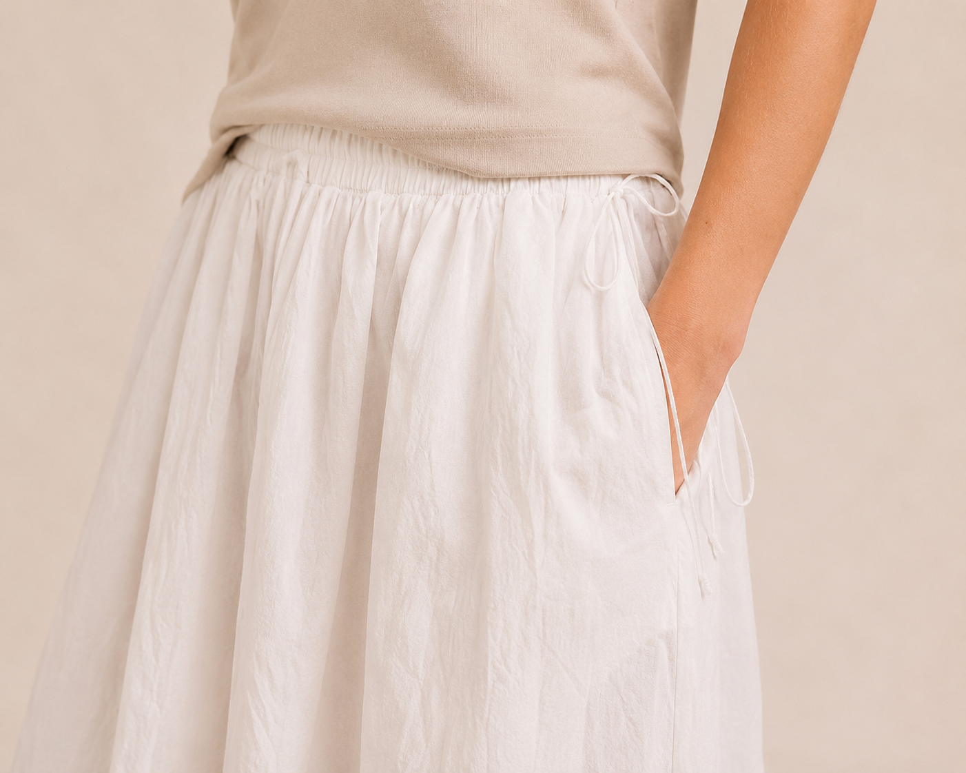 Close-up of The Flax Studio white Cotton Tie Skirt, showing the crinkled cotton texture, waistband and side pocket.