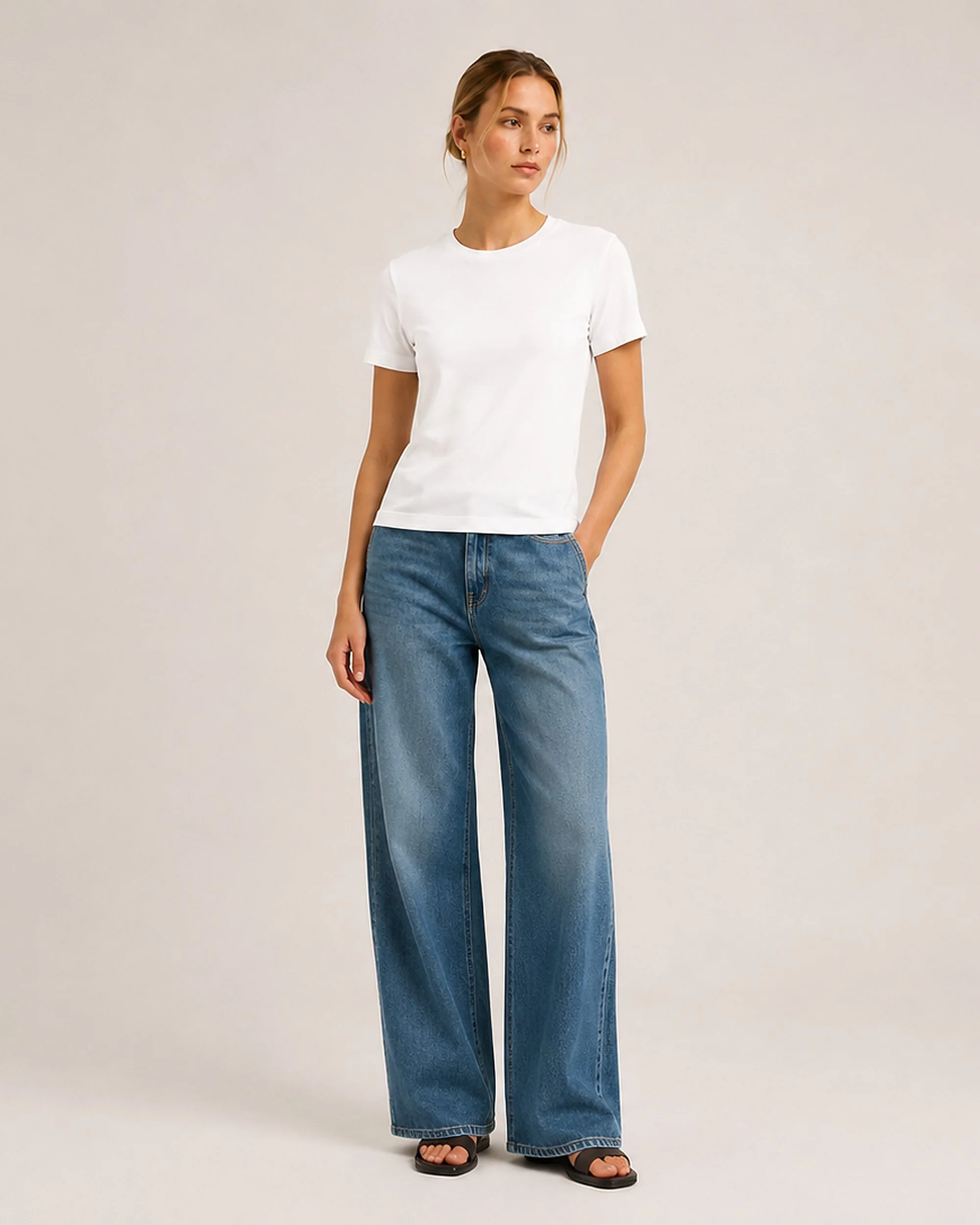 The Flax Studio white mercerised cotton crew-neck T-shirt styled with blue jeans, front view.