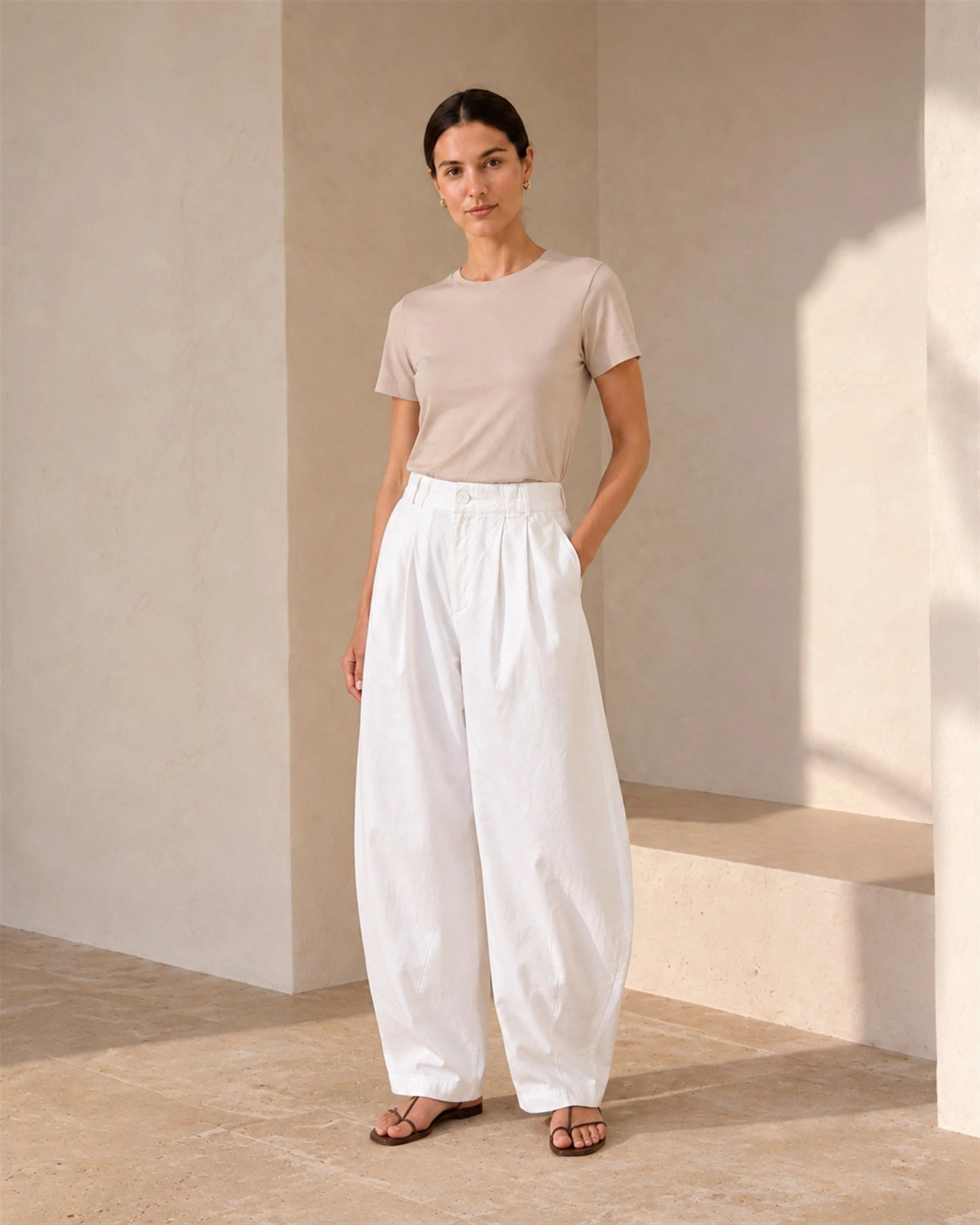 White colour option of The Flax Studio Button Front Crepe Pant styled with a beige T-shirt.