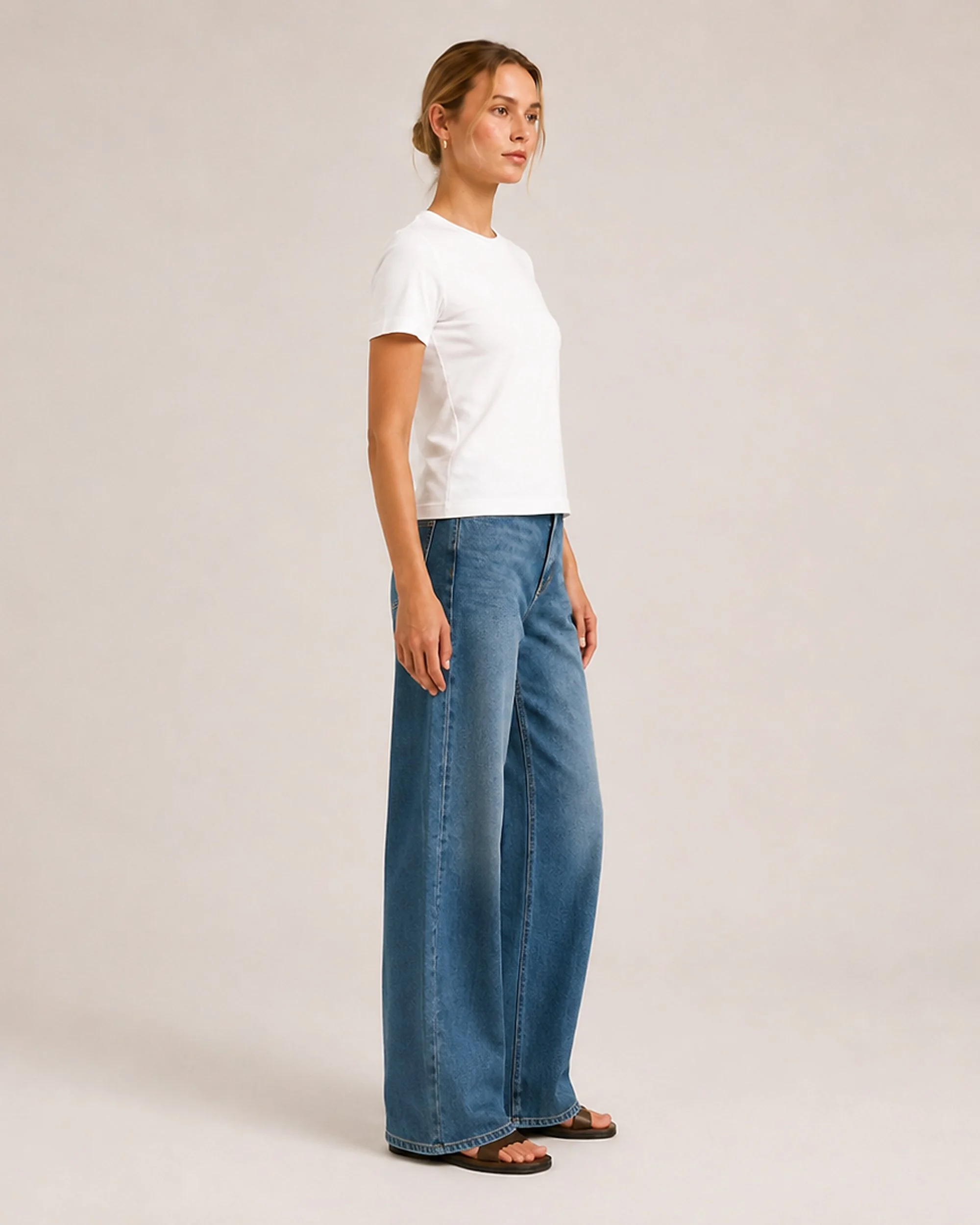 Side view of The Flax Studio white mercerised cotton T-shirt, showing its short sleeves and regular fit.