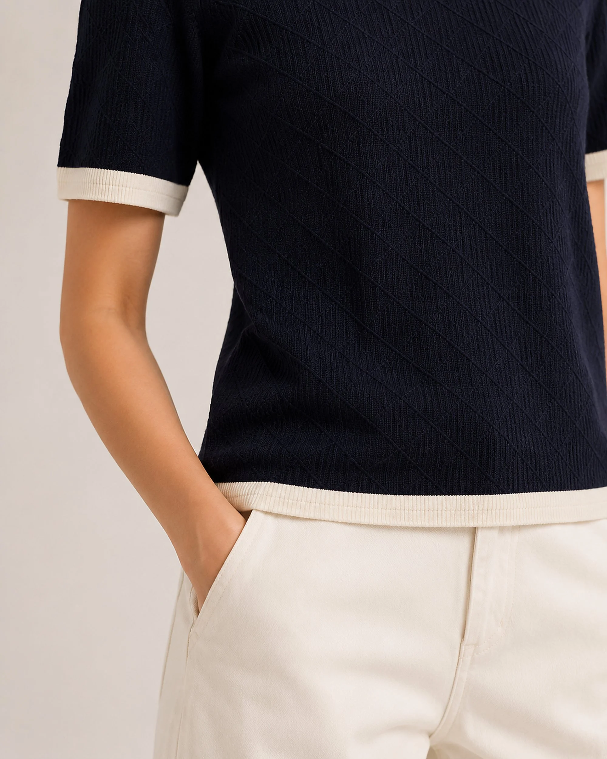 Close-up of The Flax Studio navy Contrast-Trim Silk-Cotton T-Shirt, showing the textured knit and cream hem.