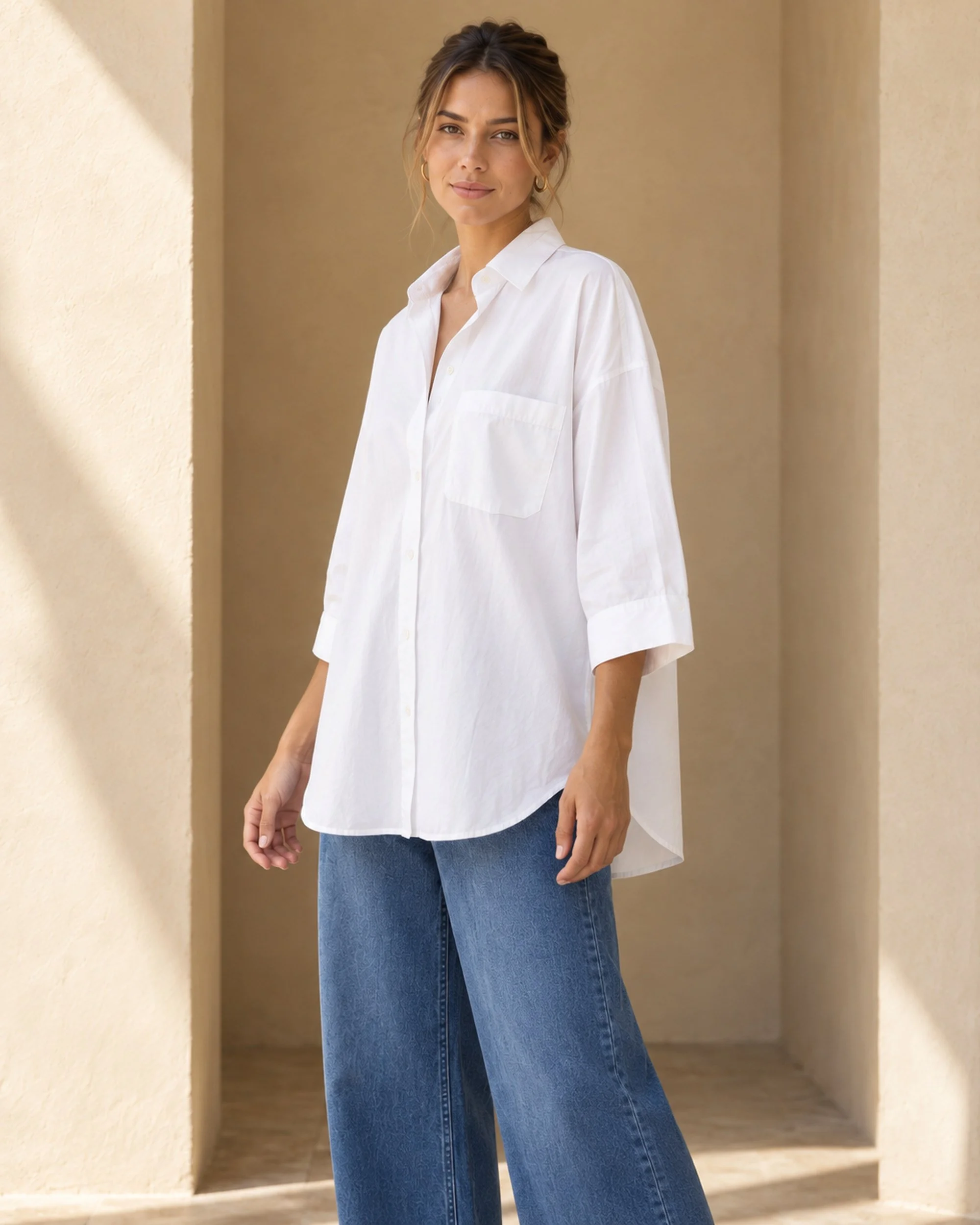 Three-quarter view of the white Oversized Cotton Shirt, showing its relaxed silhouette and three-quarter sleeves.