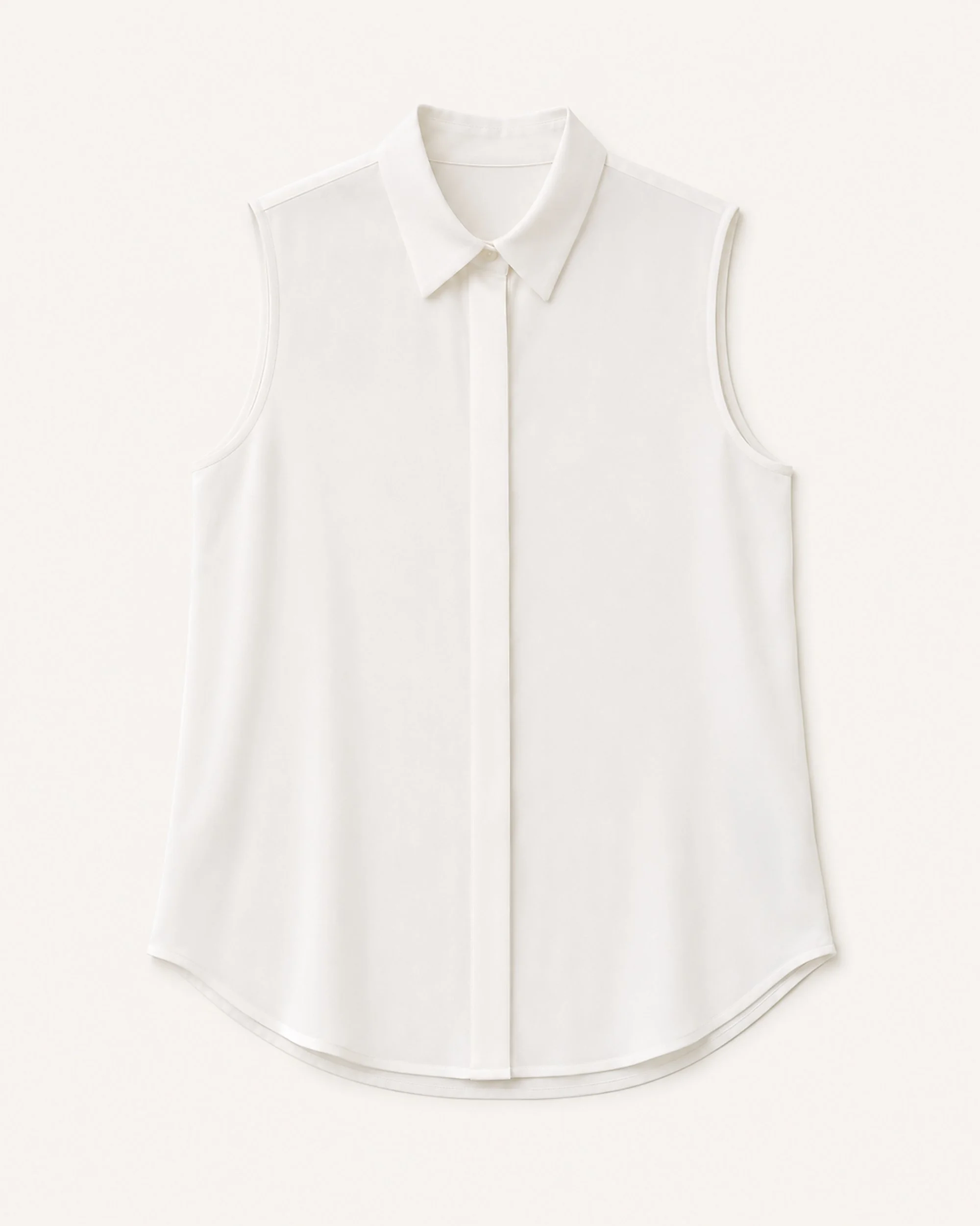 Flat lay of The Flax Studio white Mulberry Silk Sleeveless Blouse with a pointed collar and concealed placket.