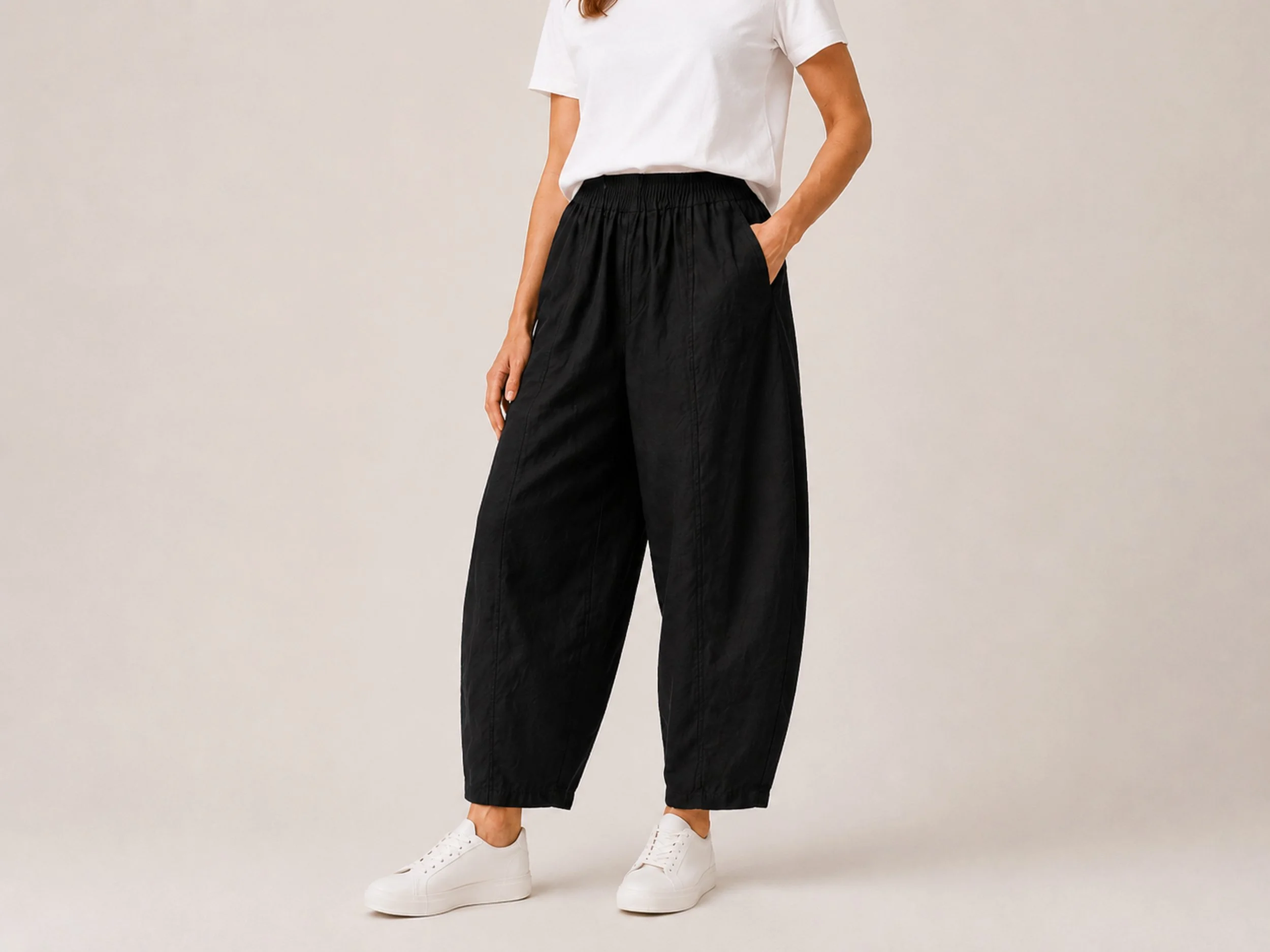 Close-up of The Flax Studio black Sculpted Cotton Pant, showing its gathered waistband and front seam detailing.