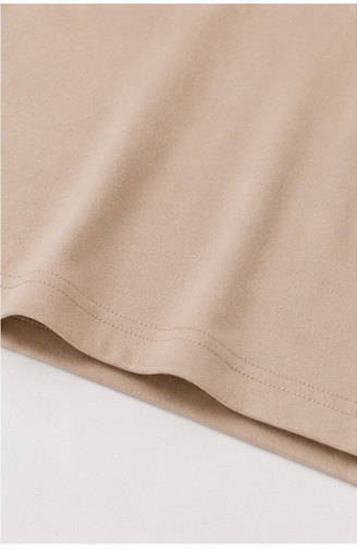 Fabric and hem detail of The Flax Studio sand mercerised cotton T-shirt.