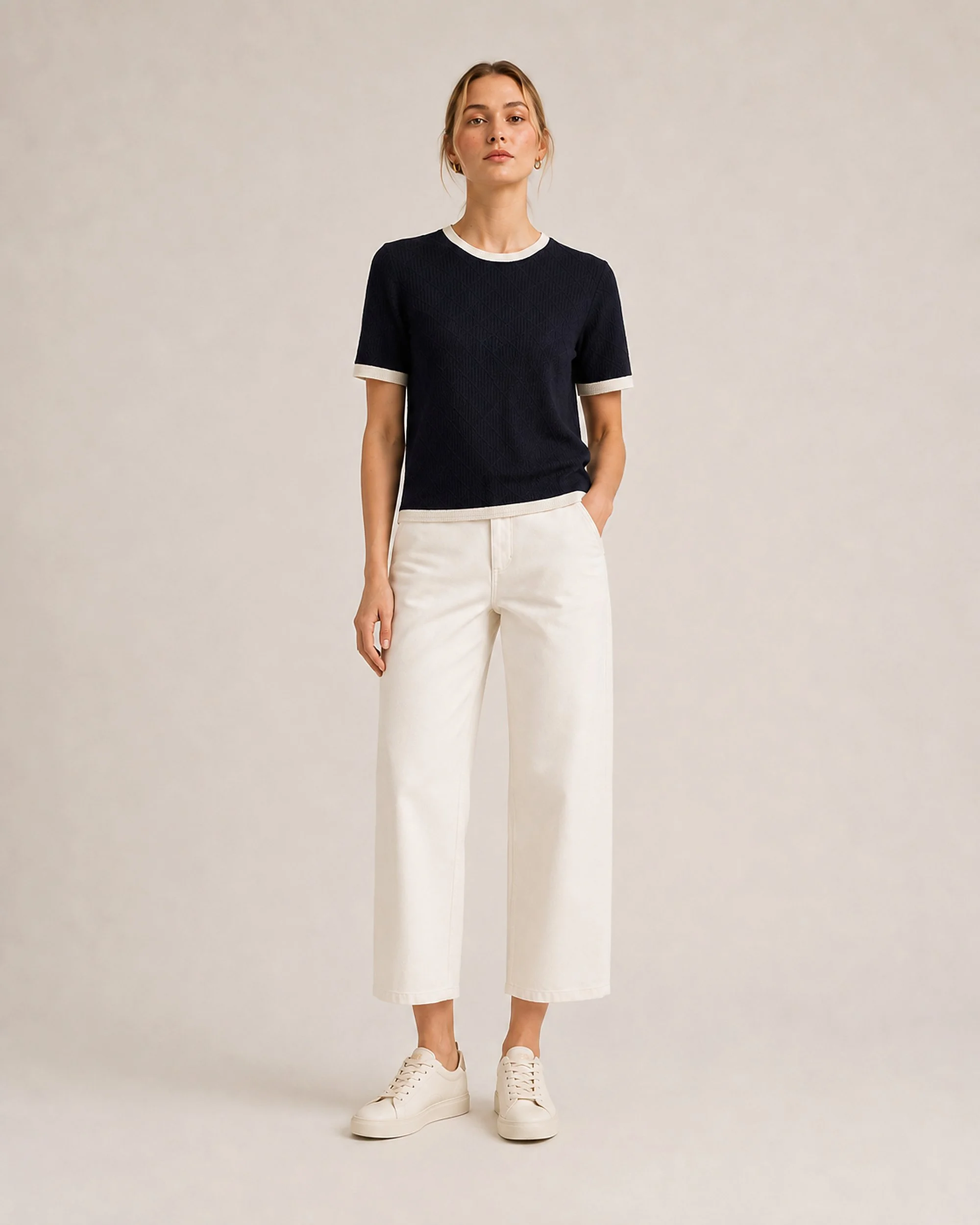 Full-length front view of The Flax Studio navy Contrast-Trim Silk-Cotton T-Shirt worn with cream trousers.