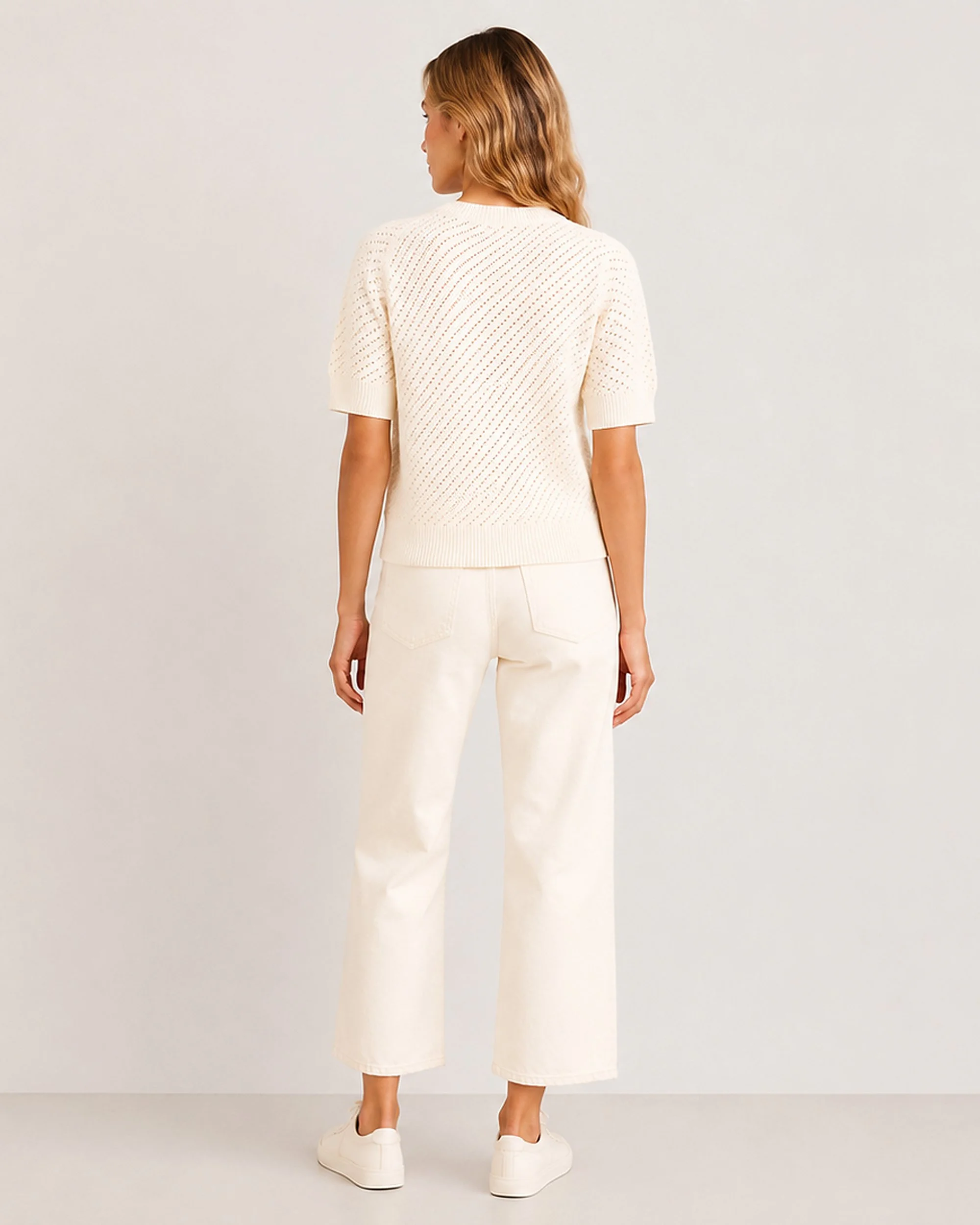 Back view of The Flax Studio cream Mulberry Silk-Cotton Pointelle Knit styled with light trousers.