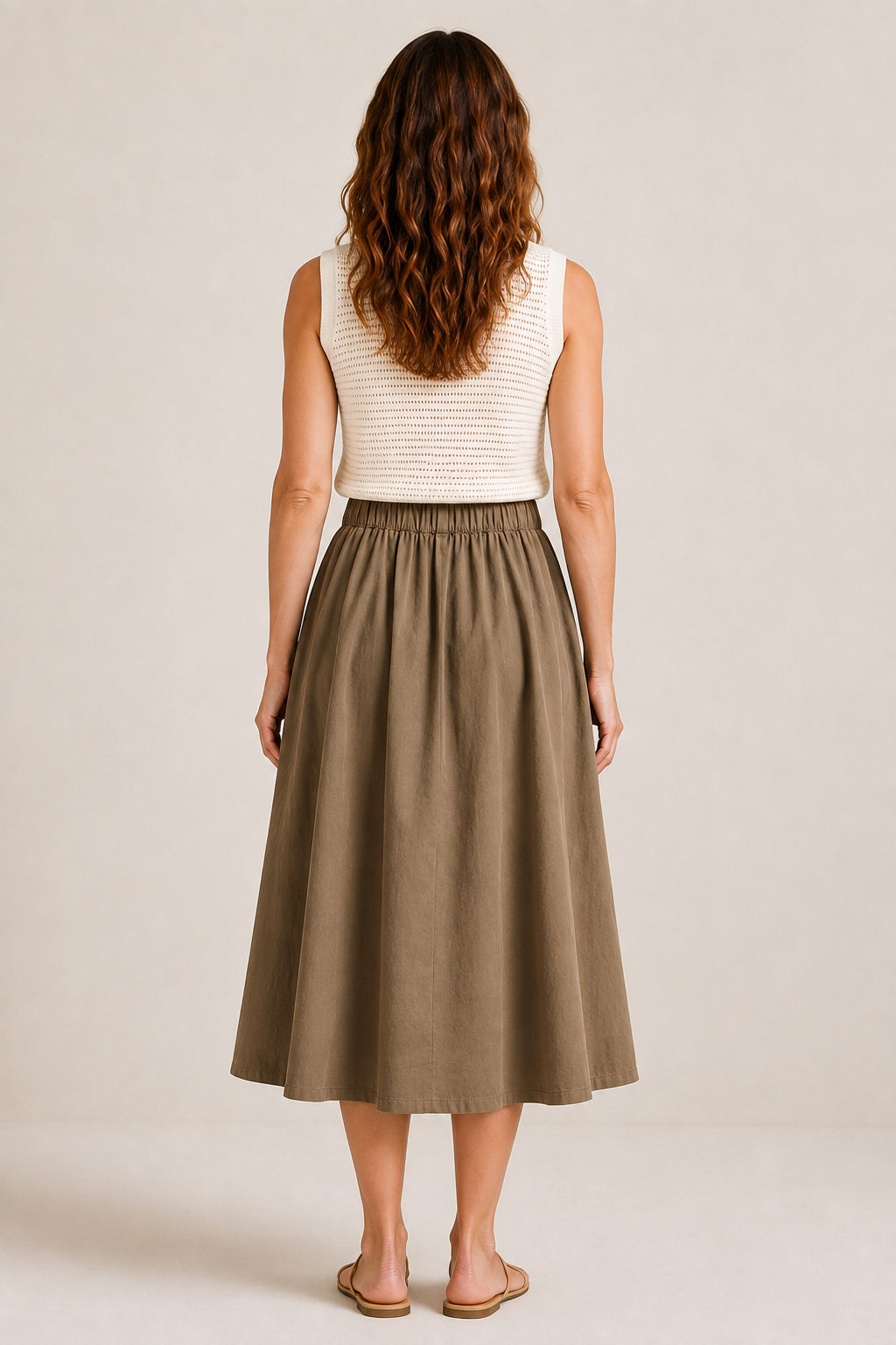 Back view of The Flax Studio khaki Button Front Skirt, showing its gathered waist and full midi silhouette.