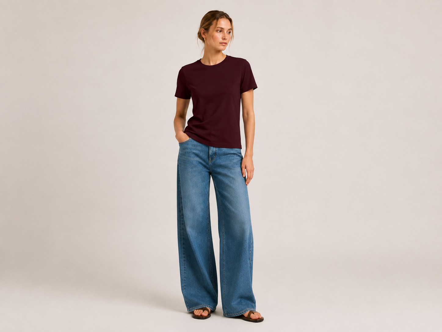 Chocolate mercerised cotton T-shirt by The Flax Studio, styled with blue jeans in a relaxed front pose.