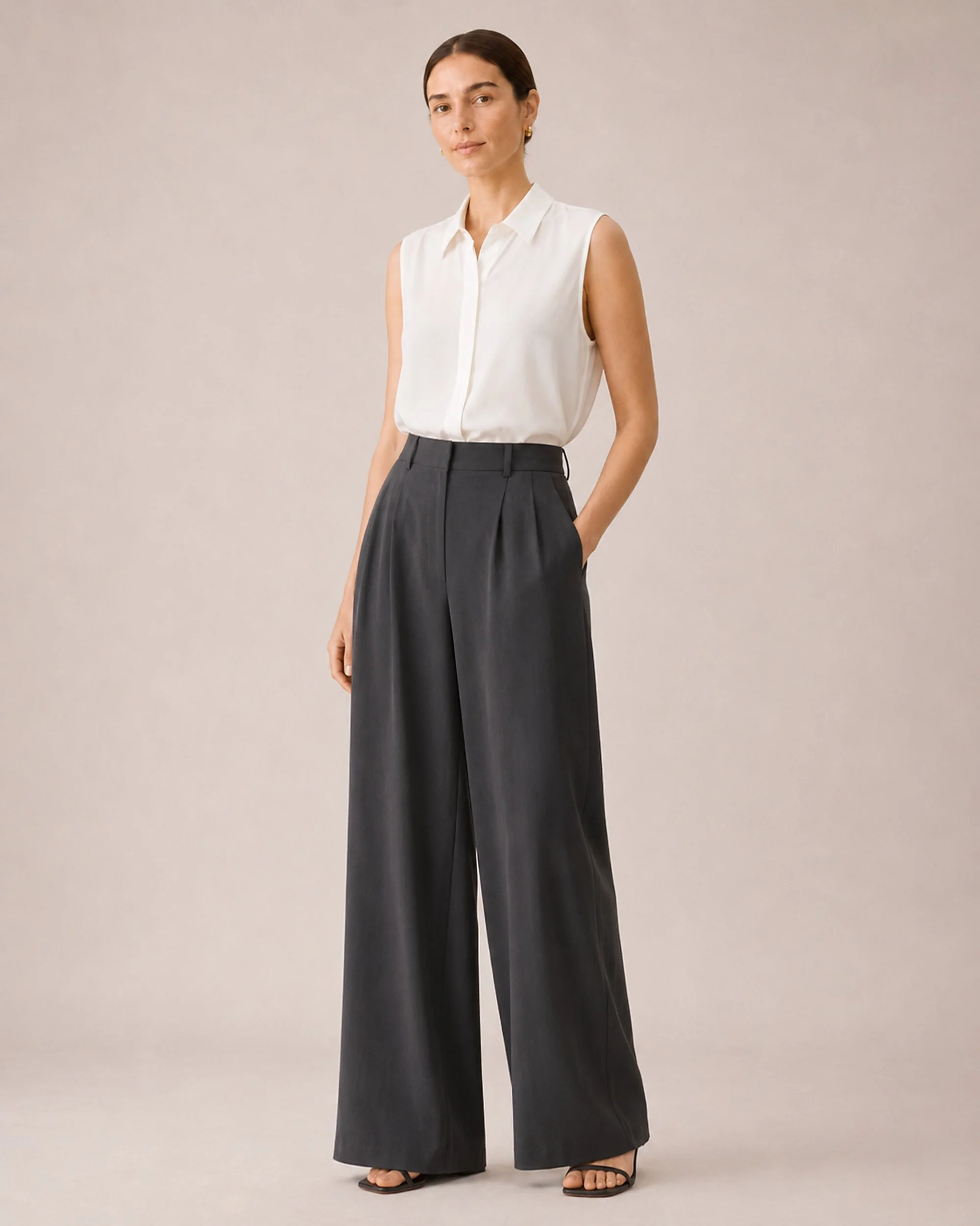 The Flax Studio white Mulberry Silk Sleeveless Blouse styled with dark wide-leg trousers.