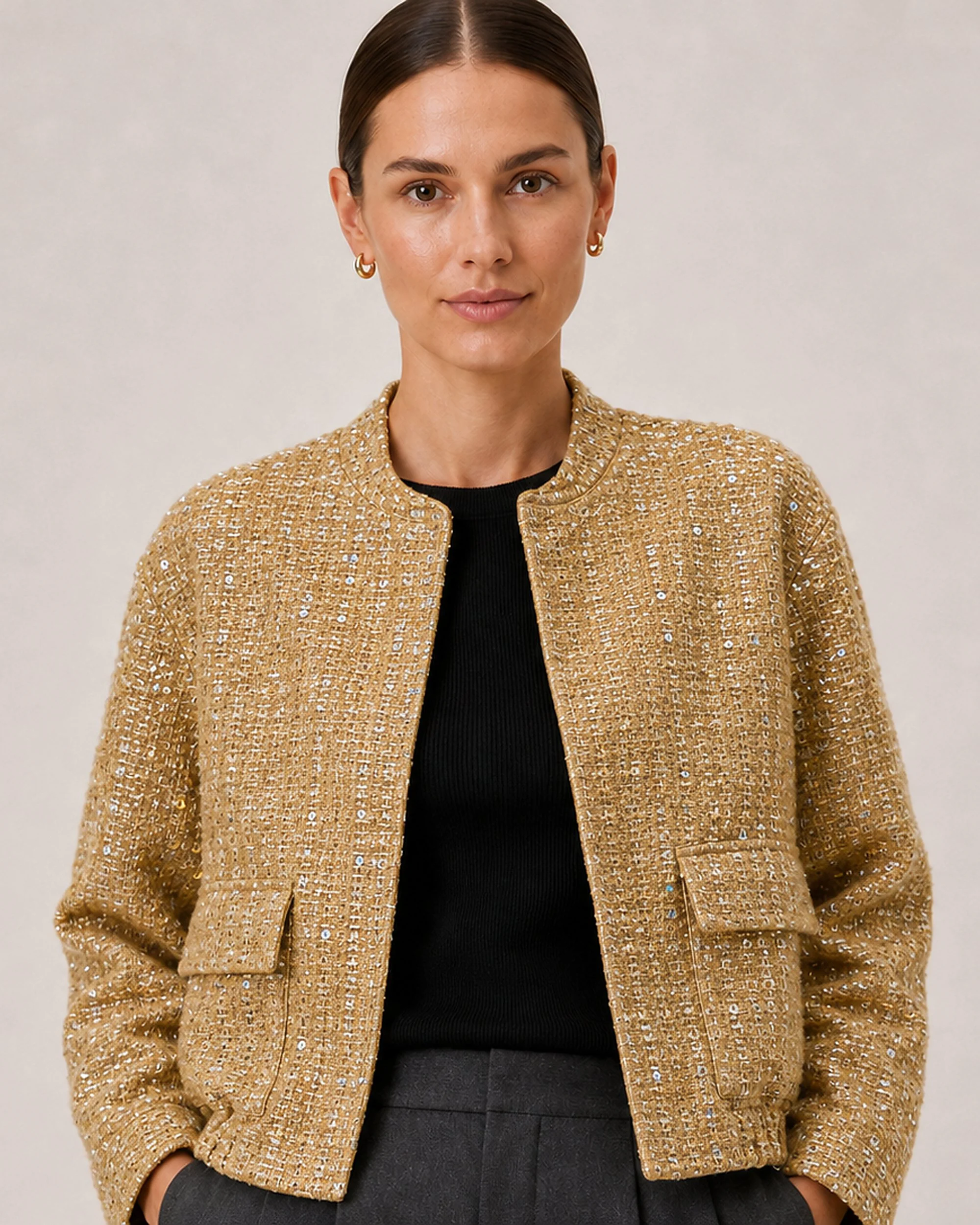 Close-up of The Flax Studio Textured Gold Jacket, showing its stand collar and gold woven texture.