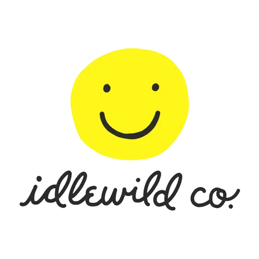 A yellow smiley face with black eyes and a curved smile above the text 'idlewild co.' in handwritten style.