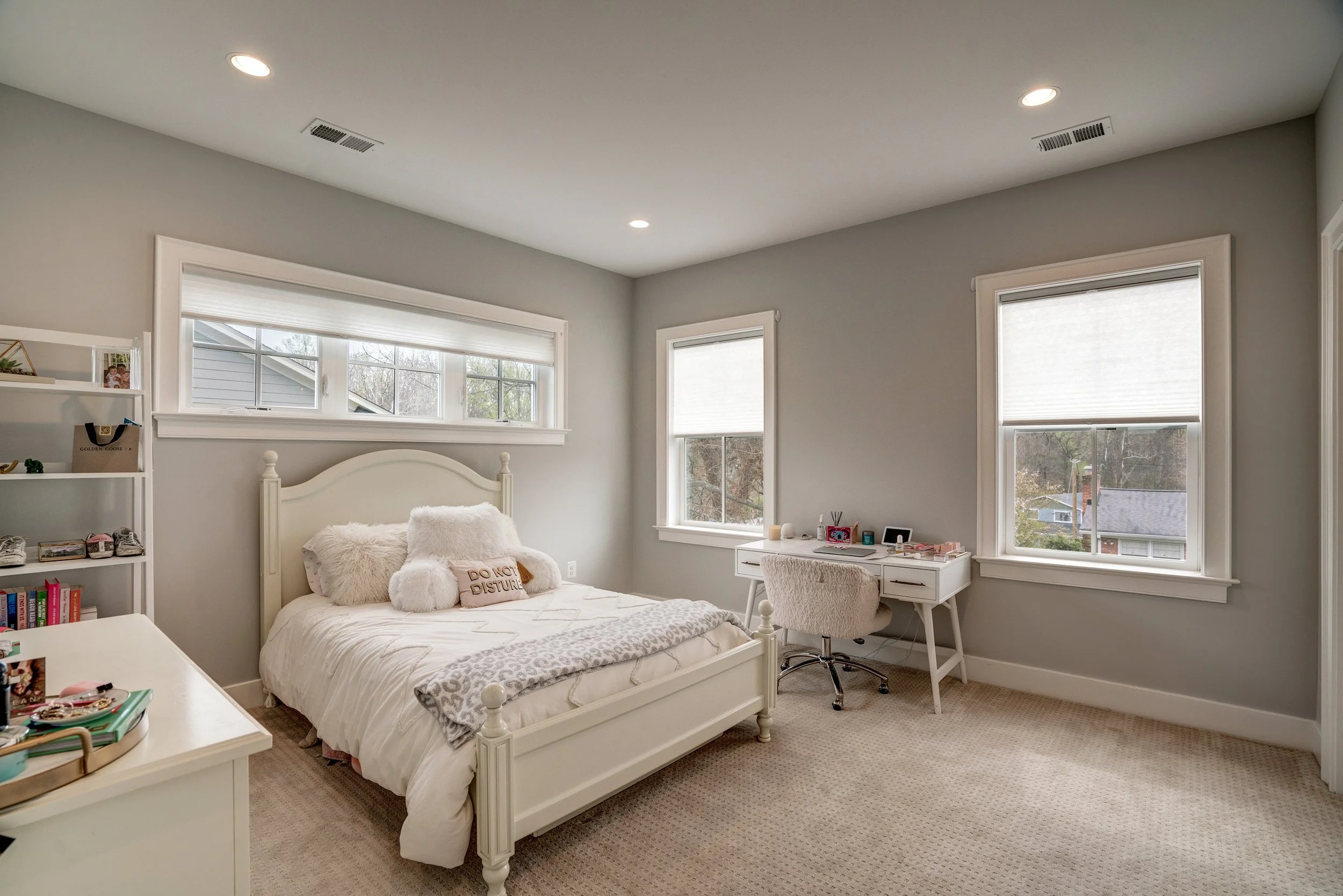 A cozy bedroom with a white bed, fluffy pillows, and a 