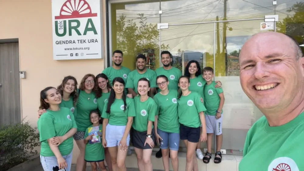 Dan with the Tek Ura team in matching green T-shirts outside the Tirana centre