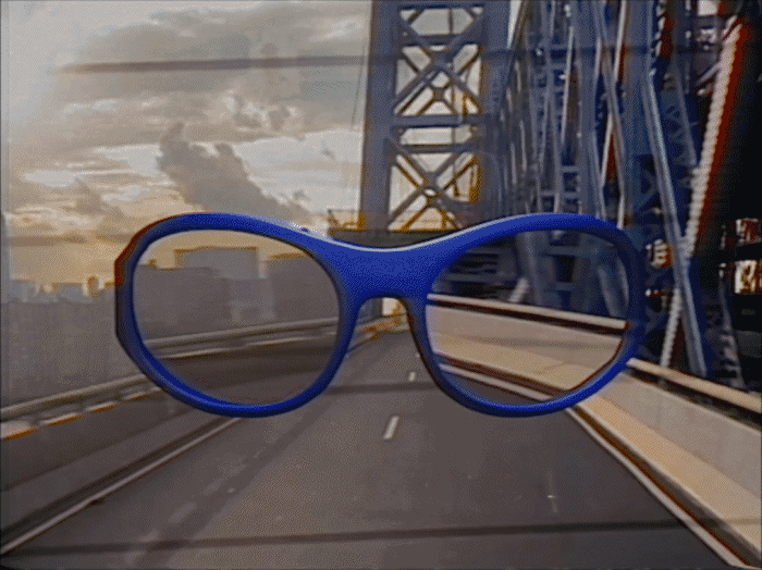 A pair of blue sunglasses appears to be floating in front of a bridge and a highway, creating a visual illusion.