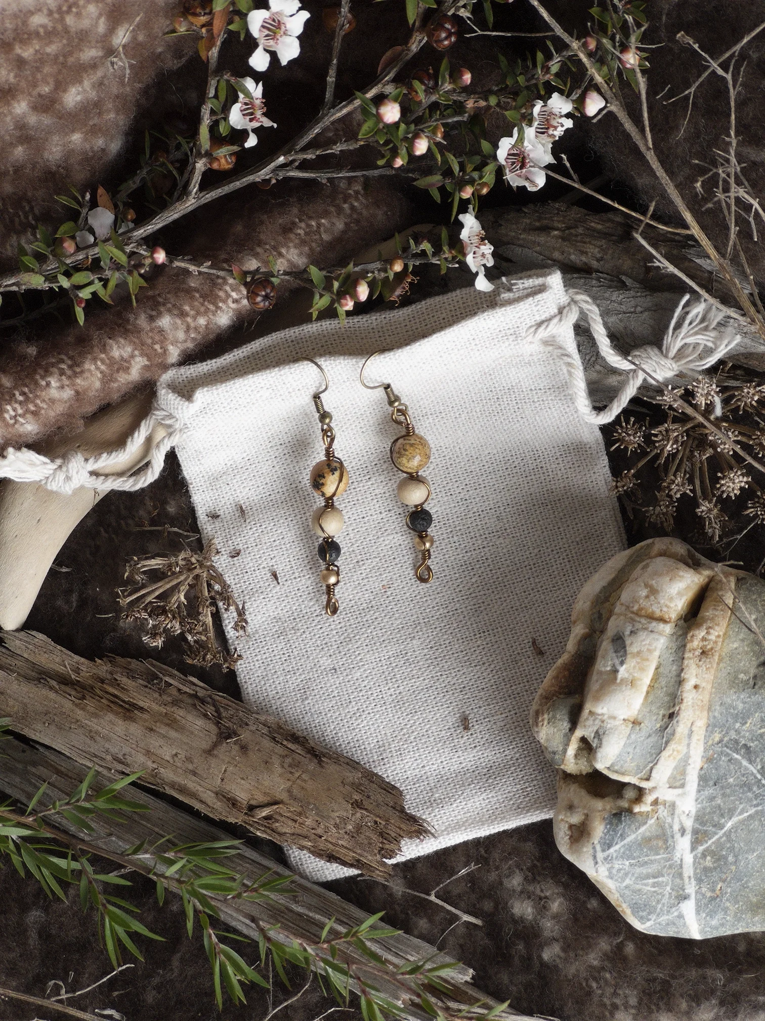 Bronze Earrings White Bag.webp