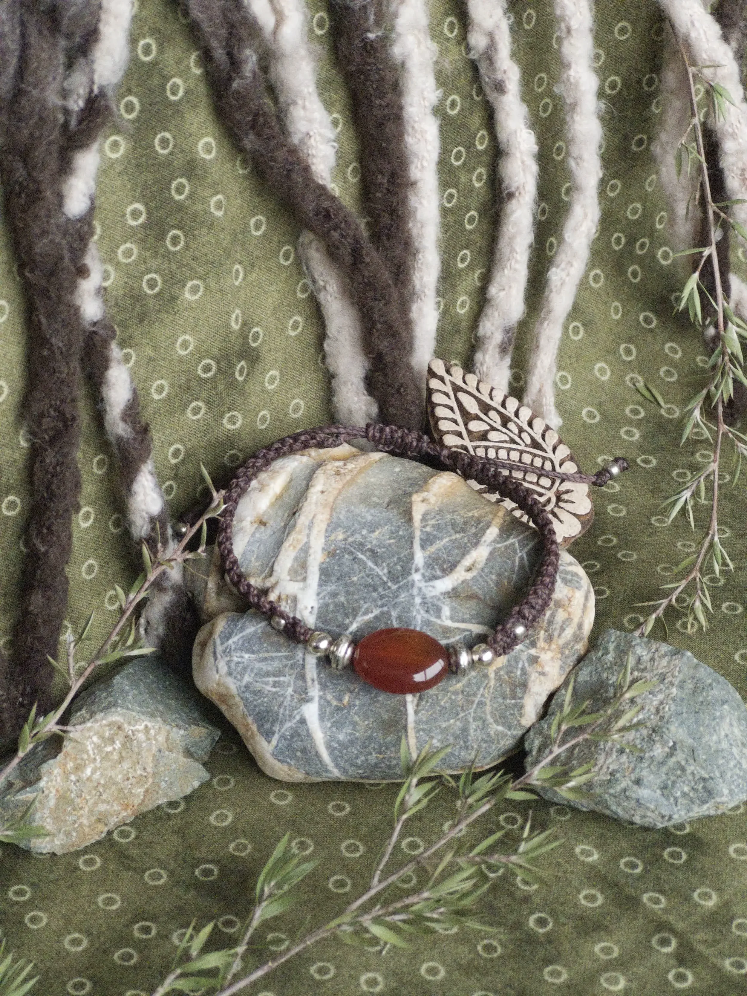 carnelian bracelet on stone.webp