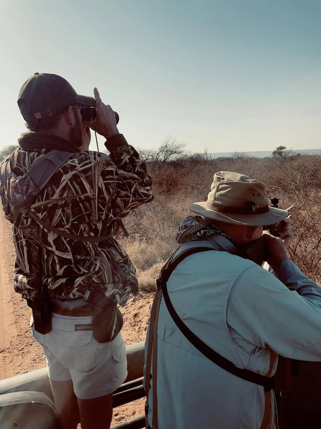 Burt and the author’s father glassing from a safari vehicle in South Africa.